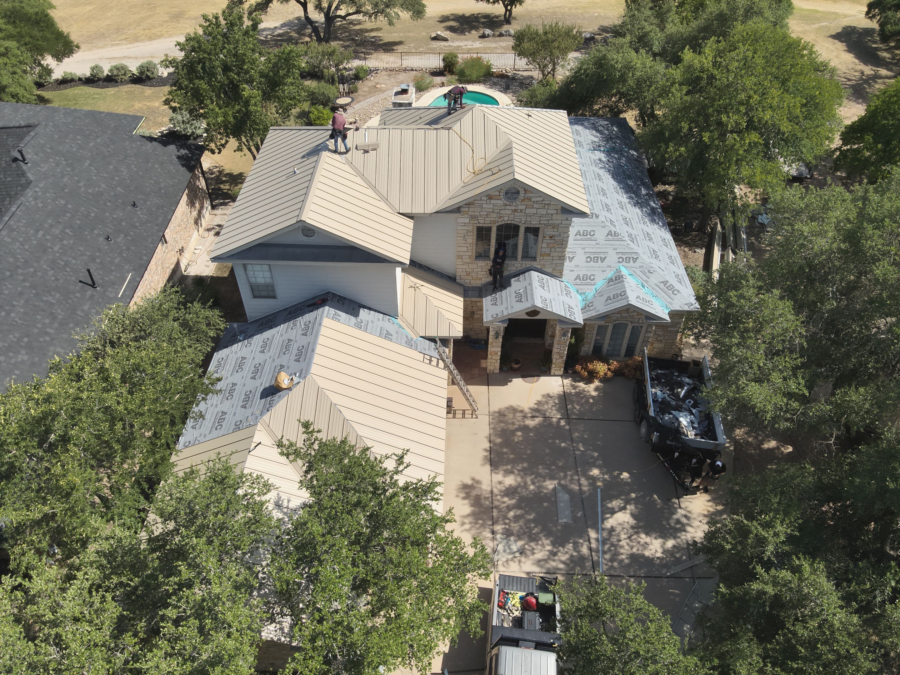 Residential Roof Replacement using 24 GA Double-Lock - Surrey Beige by Action Exteriors Austin
