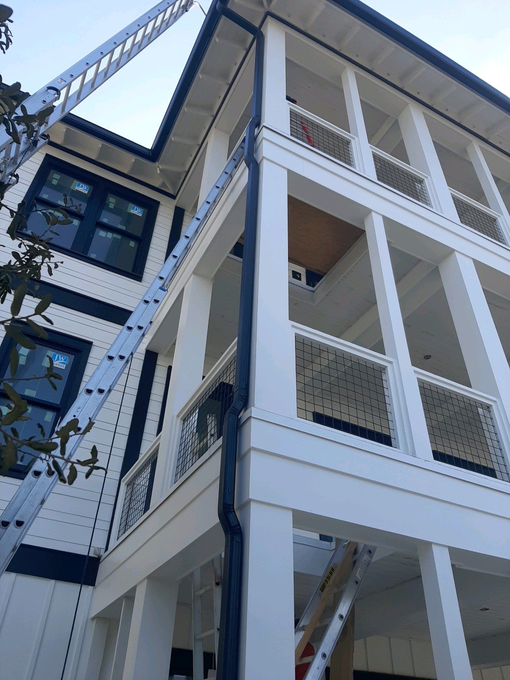 Seamless Gutter Installation Using Black Half Round Seamless Gutters by Gutter Professors