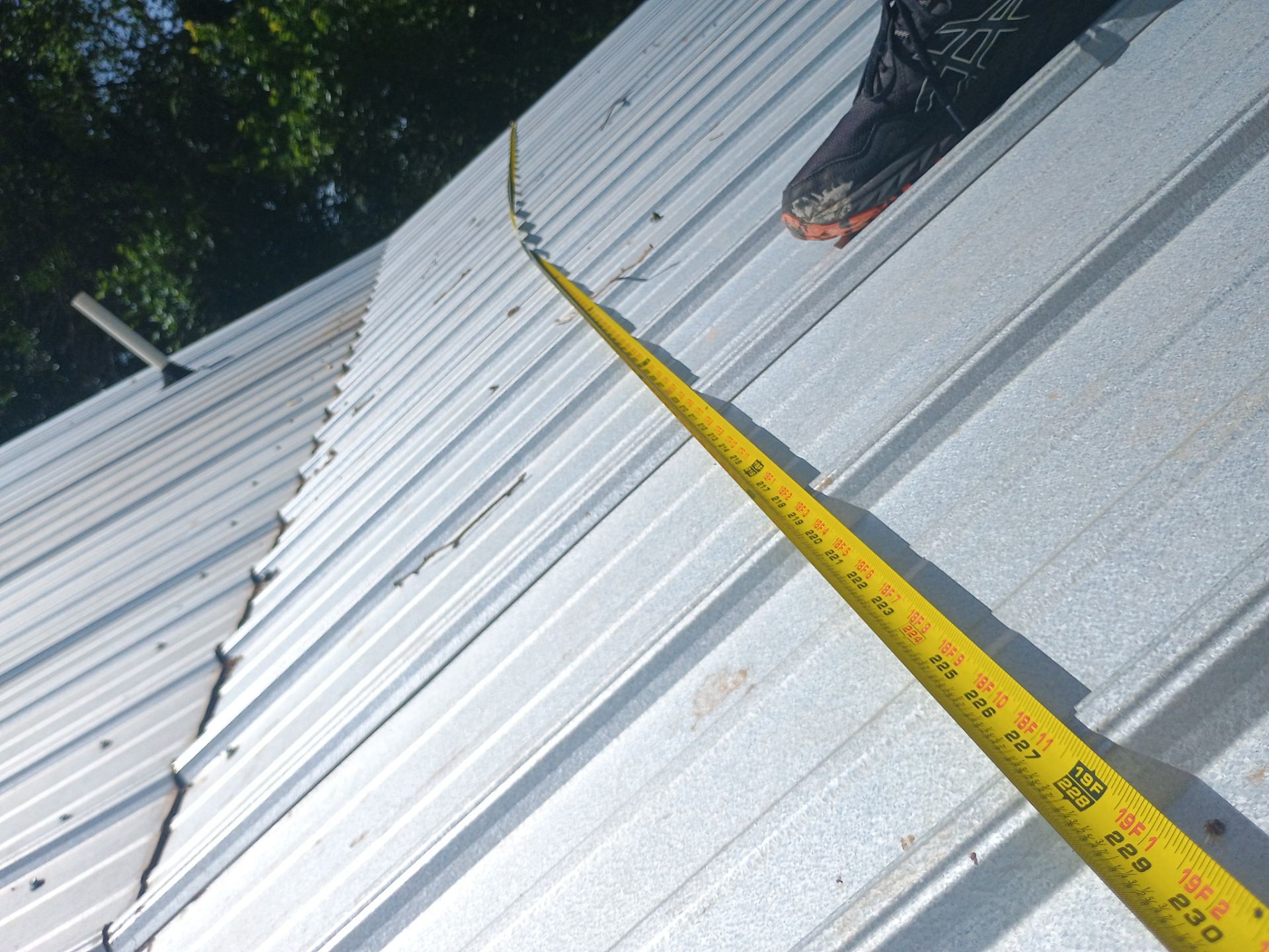 Corrugated Metal Roof Repair for Brick Home in Lindsay by BANA Roofing and Solar Supply