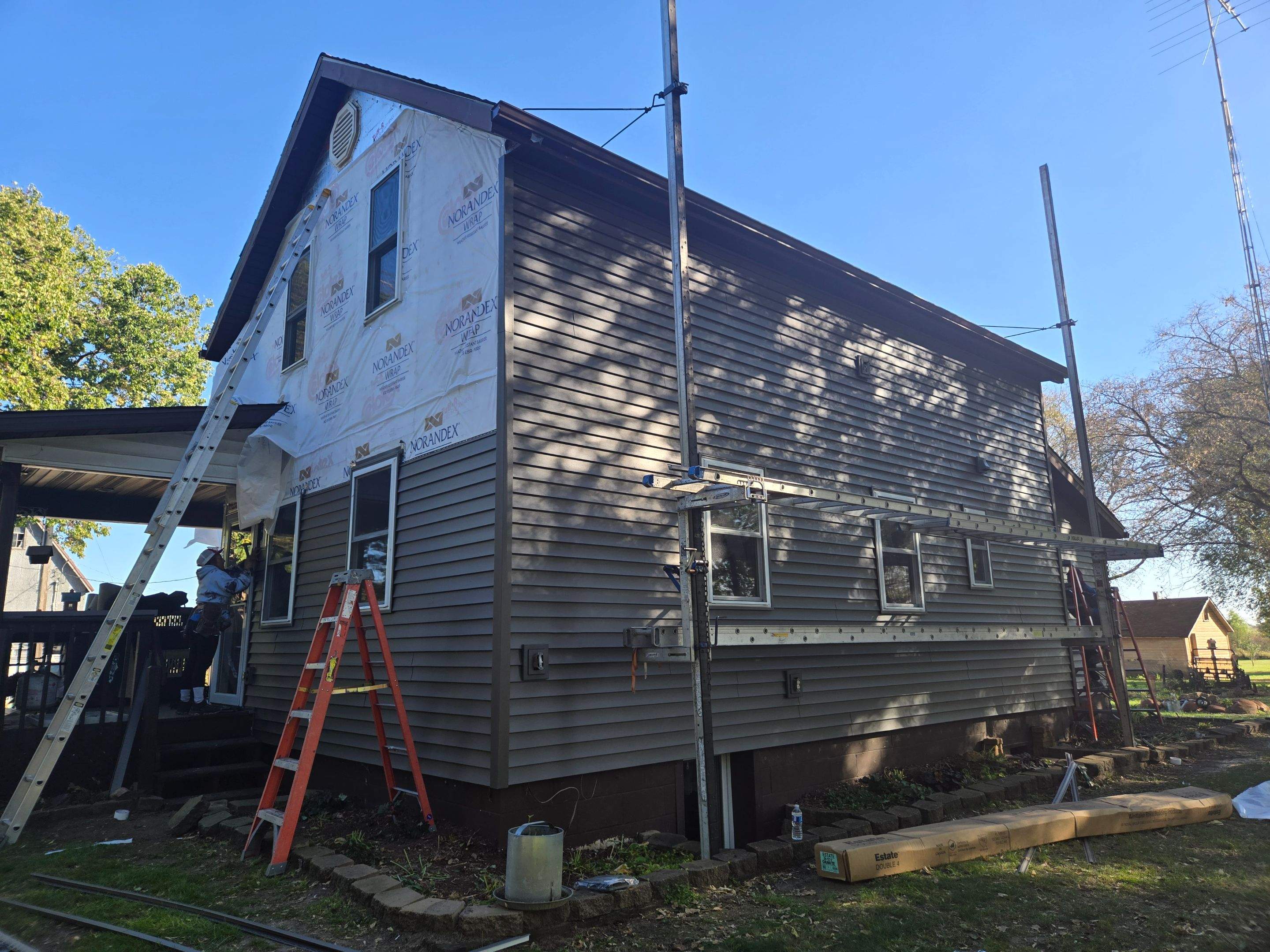 Royal Granite Siding Replacement & Brown Seamless Gutters by Next Level Seamless Gutters / Exteriors Inc.