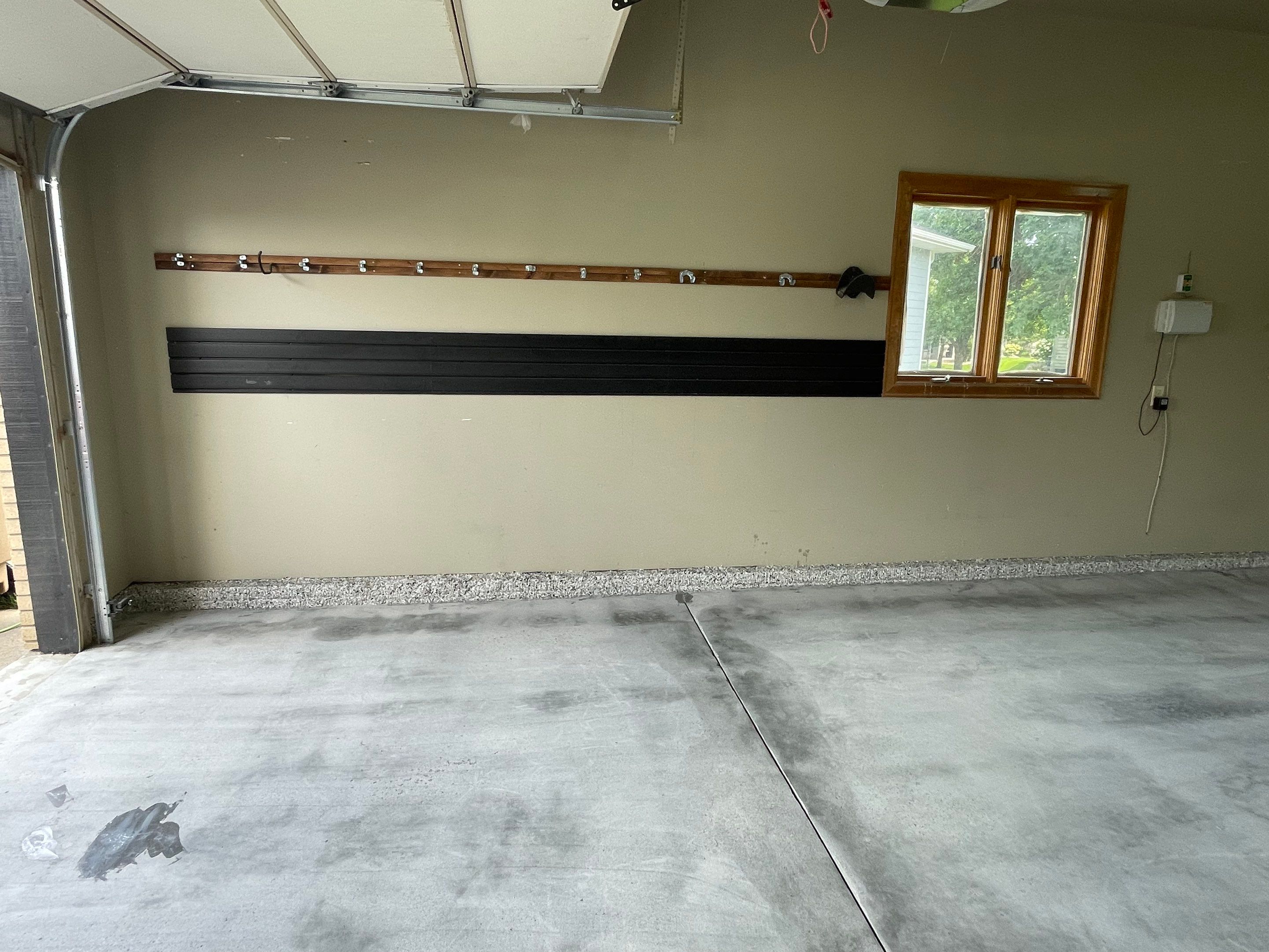 Cabin FEver Flake Garage Floor Coating Installation in Sioux Falls by Select Painting, Coatings & Garage Cabinets