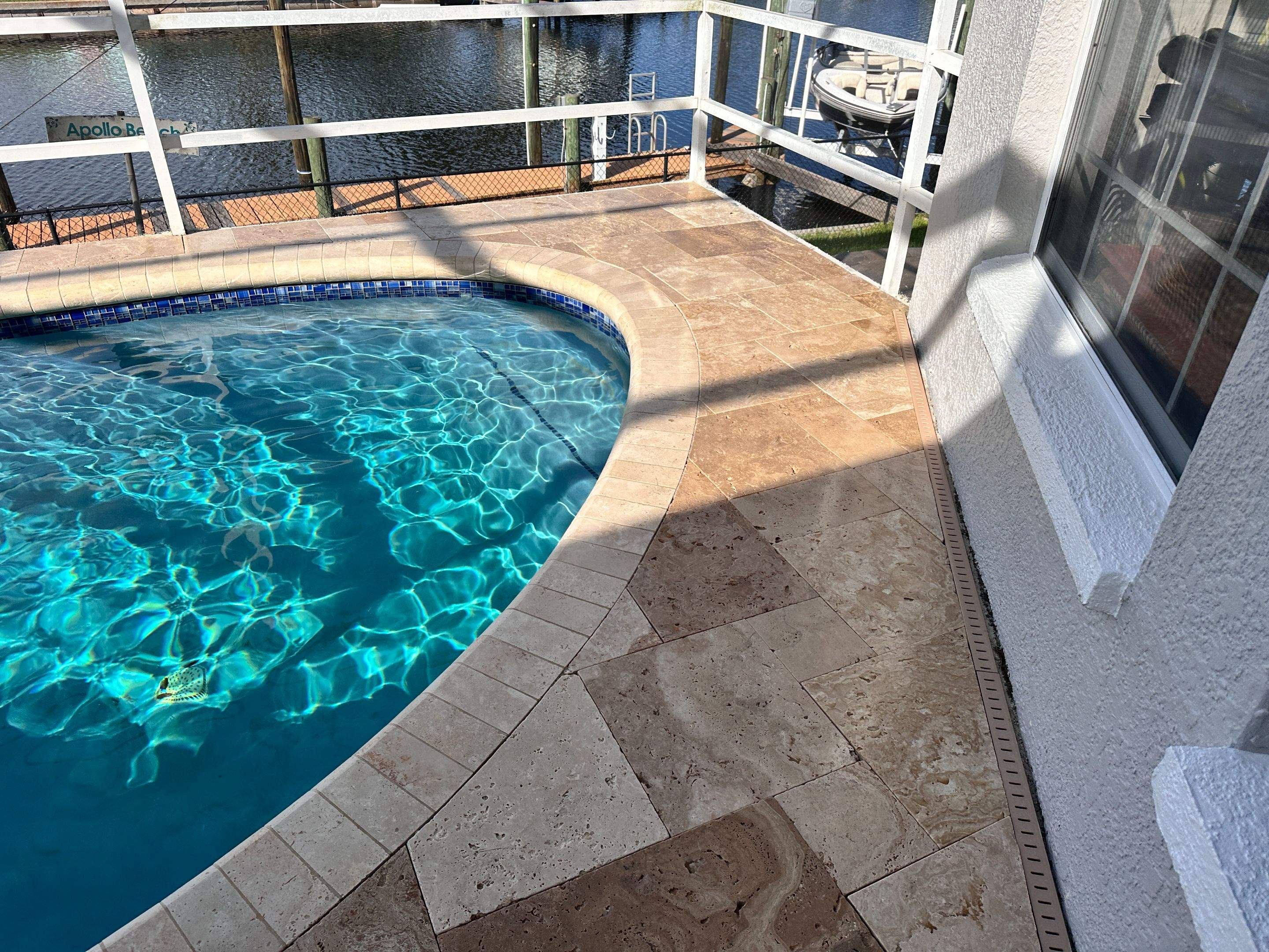Travertine Sealing and Stripping for a Waterfront Pool Deck in Apollo Beach by Supreme Paver Experts