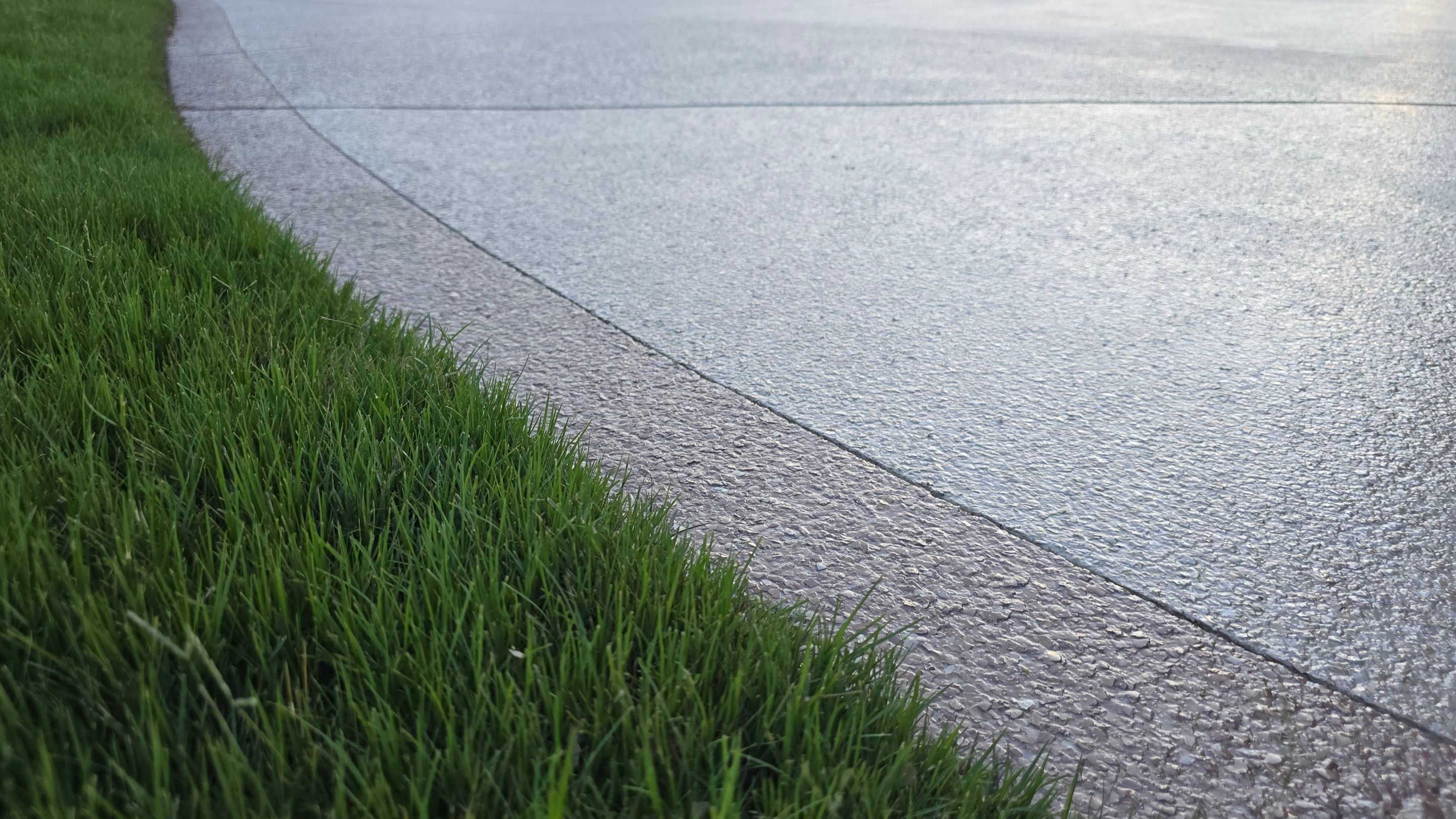 Driveway and sidewalk using Feldspar with the border done in Spilite by Elite Floor Solutions