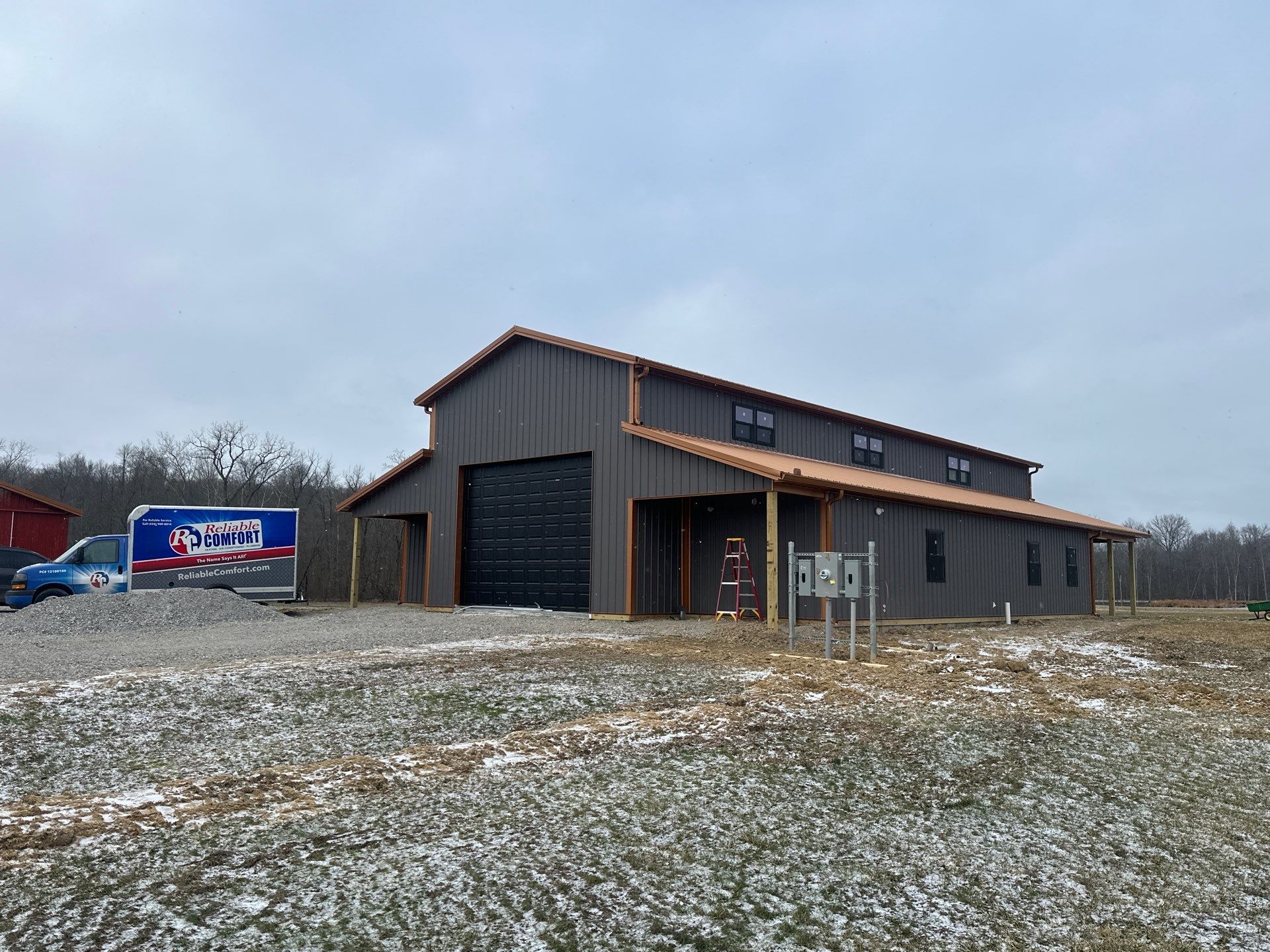 Custom Pole Barn Home with Charcoal Siding and Copper Roof by The Barn Builders
