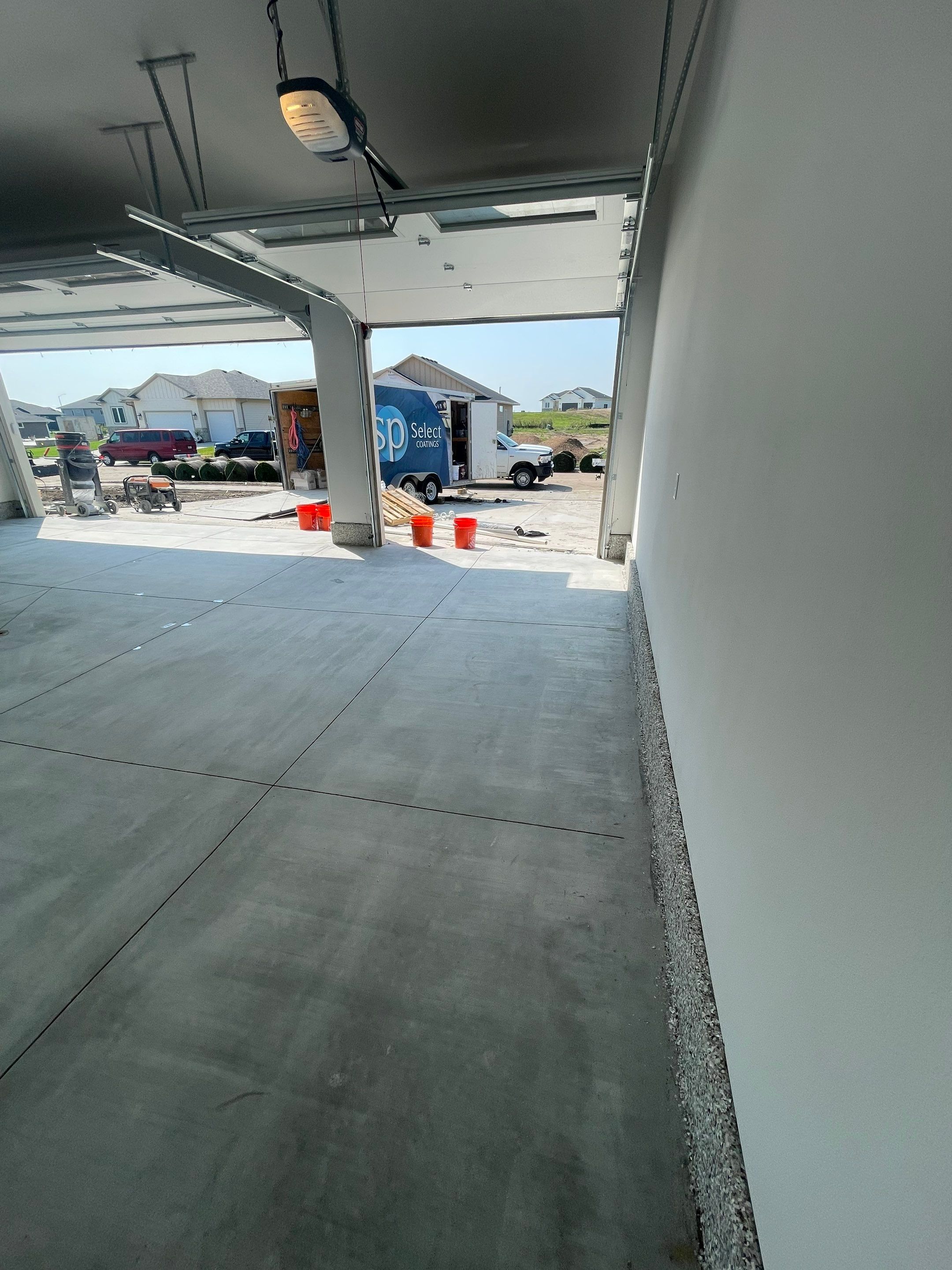 Grey Speckled Garage Floor Coating in Sioux Falls by Select Painting, Coatings & Garage Cabinets