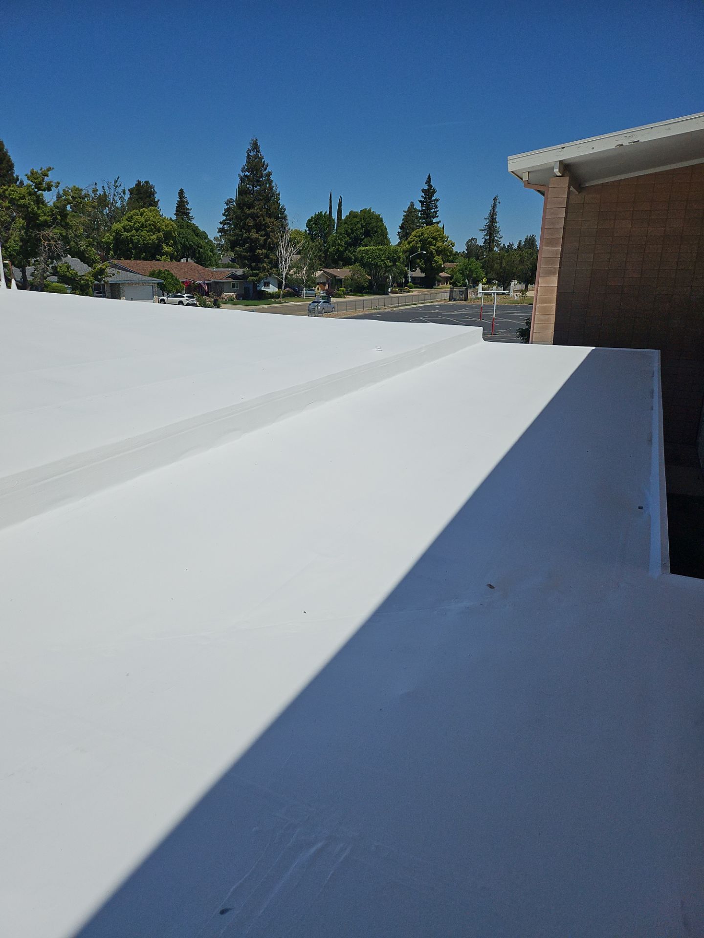 Single-ply restoration system using Benchmark/PUMA XL coatings over TPO single-ply roofing by Straight Edge Roofing Inc
