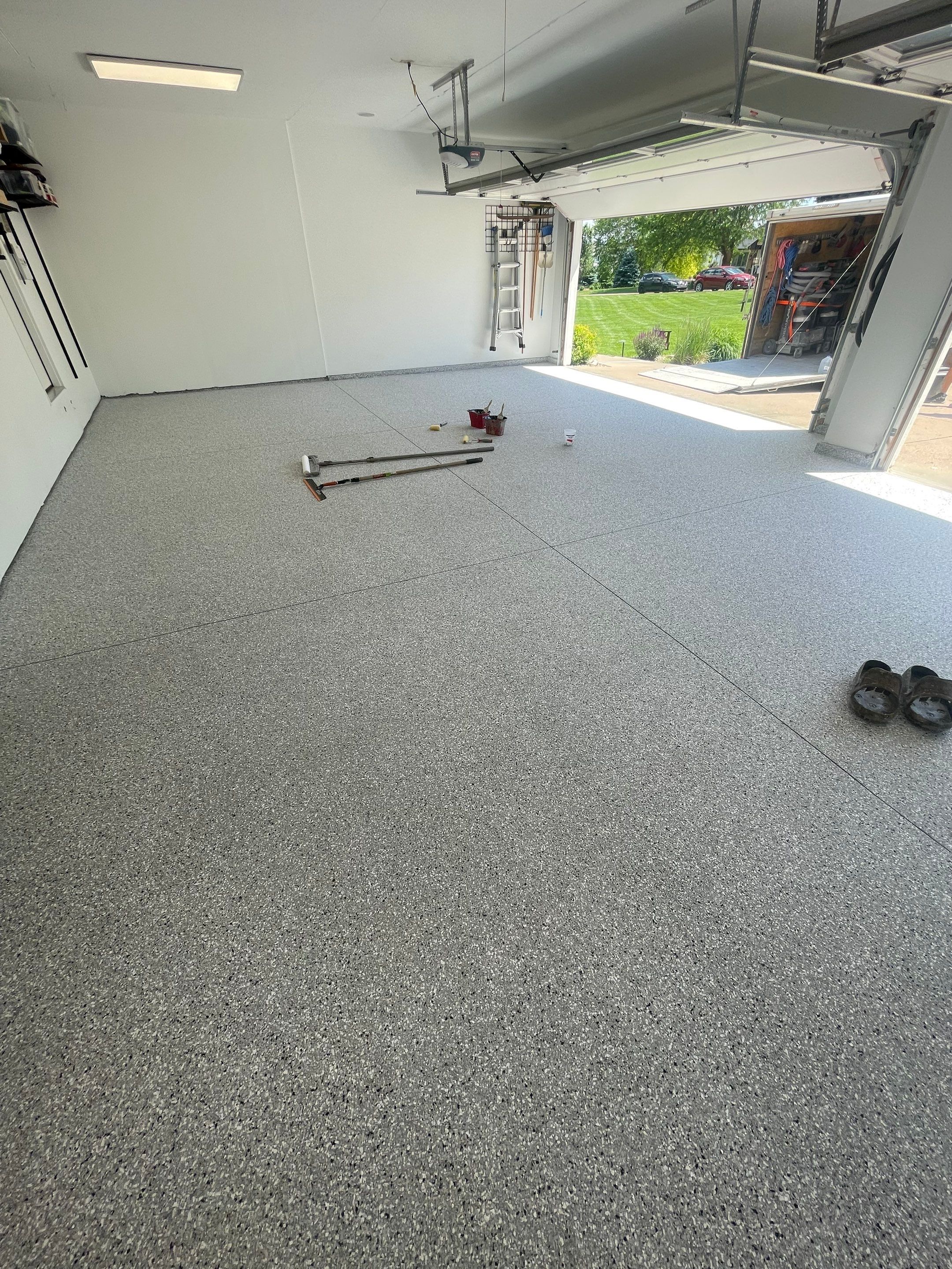 Feather Grey Garage Floor Coating Installation in Sioux Falls by Select Painting, Coatings & Garage Cabinets