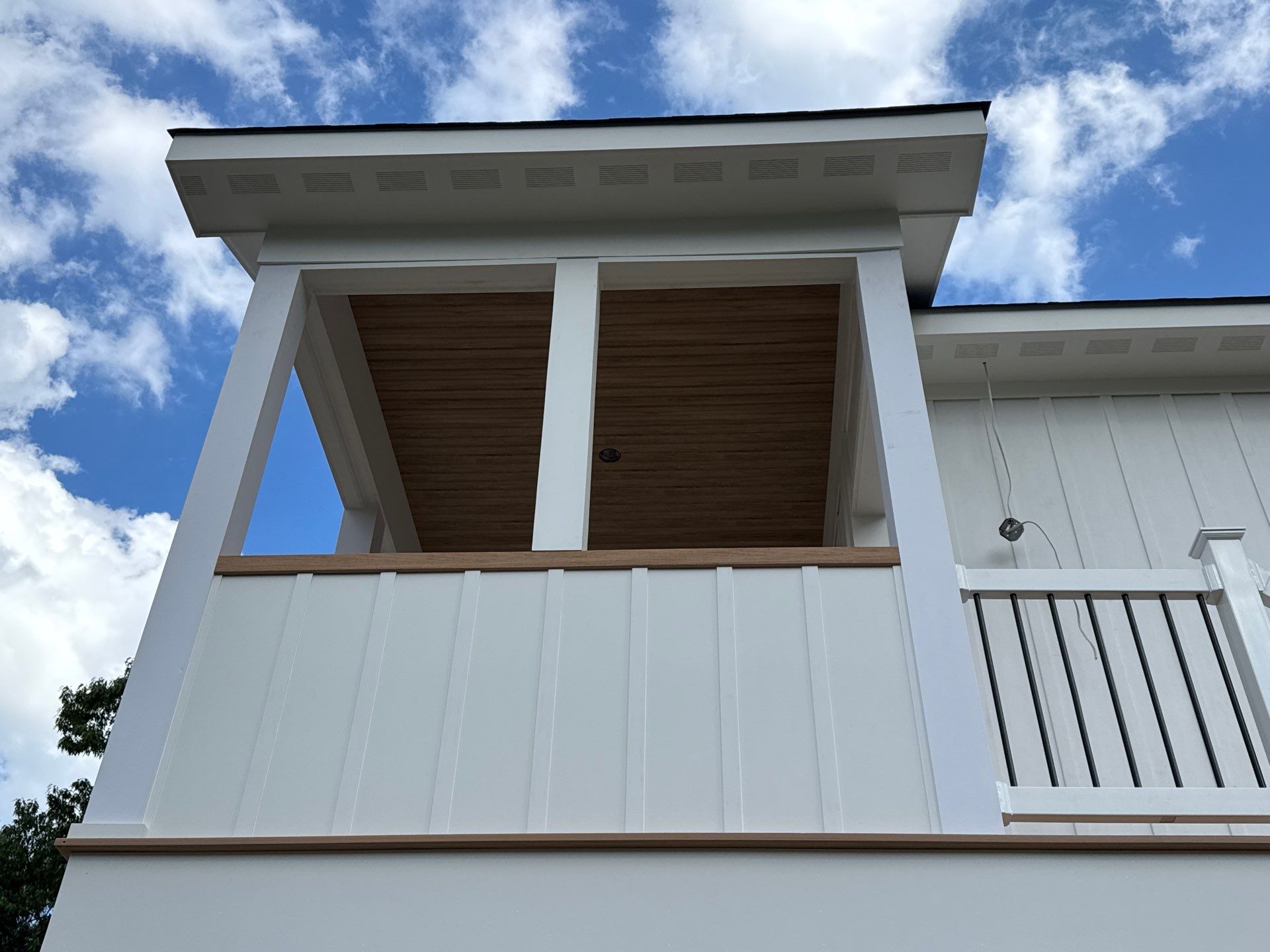 Two-Story Custom Home With Board and Batten Siding by Cade Construction