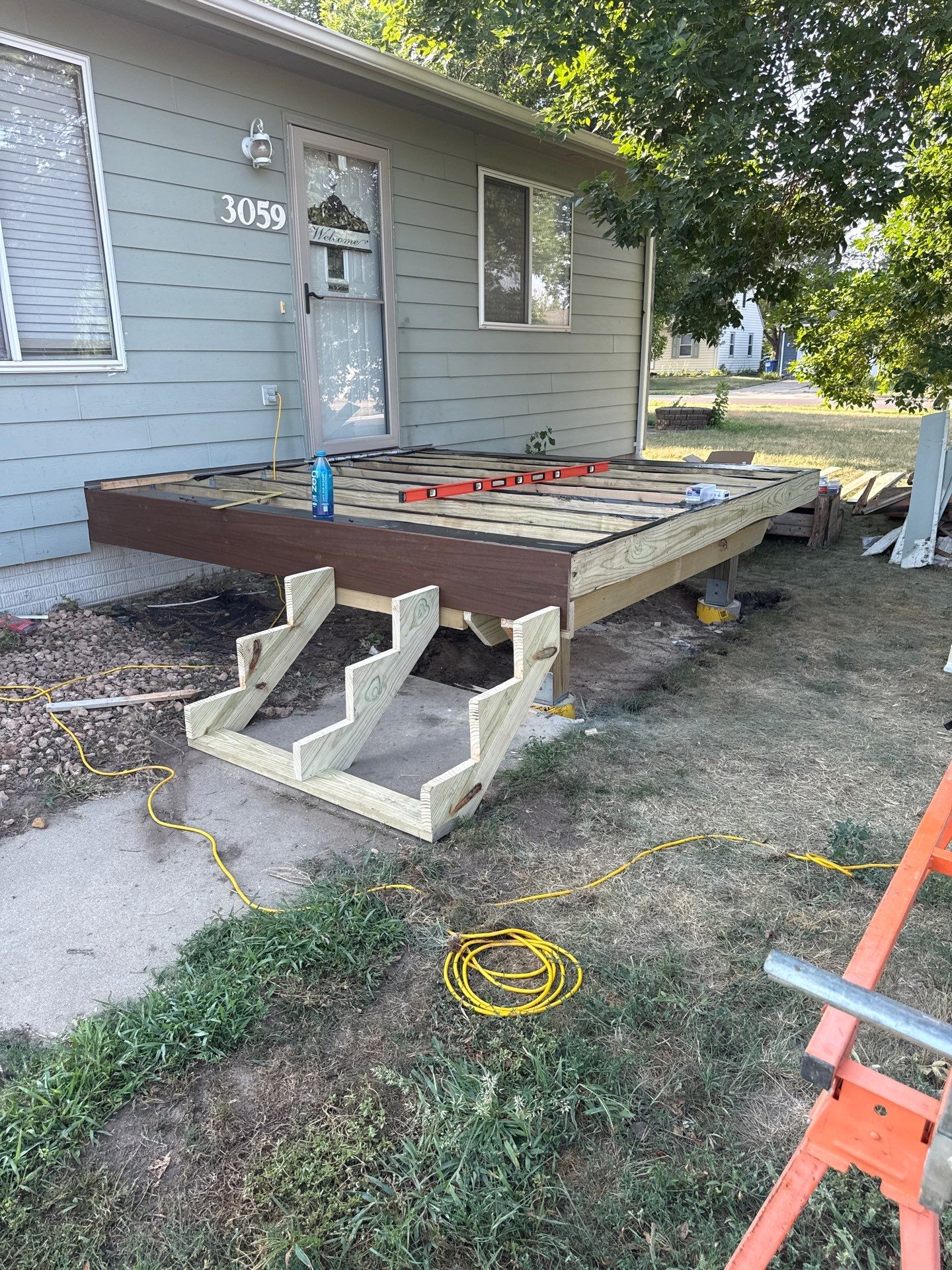 Sioux Falls Front Entry Composite Deck Build with Metal Railings by Select Painting, Coatings & Garage Cabinets