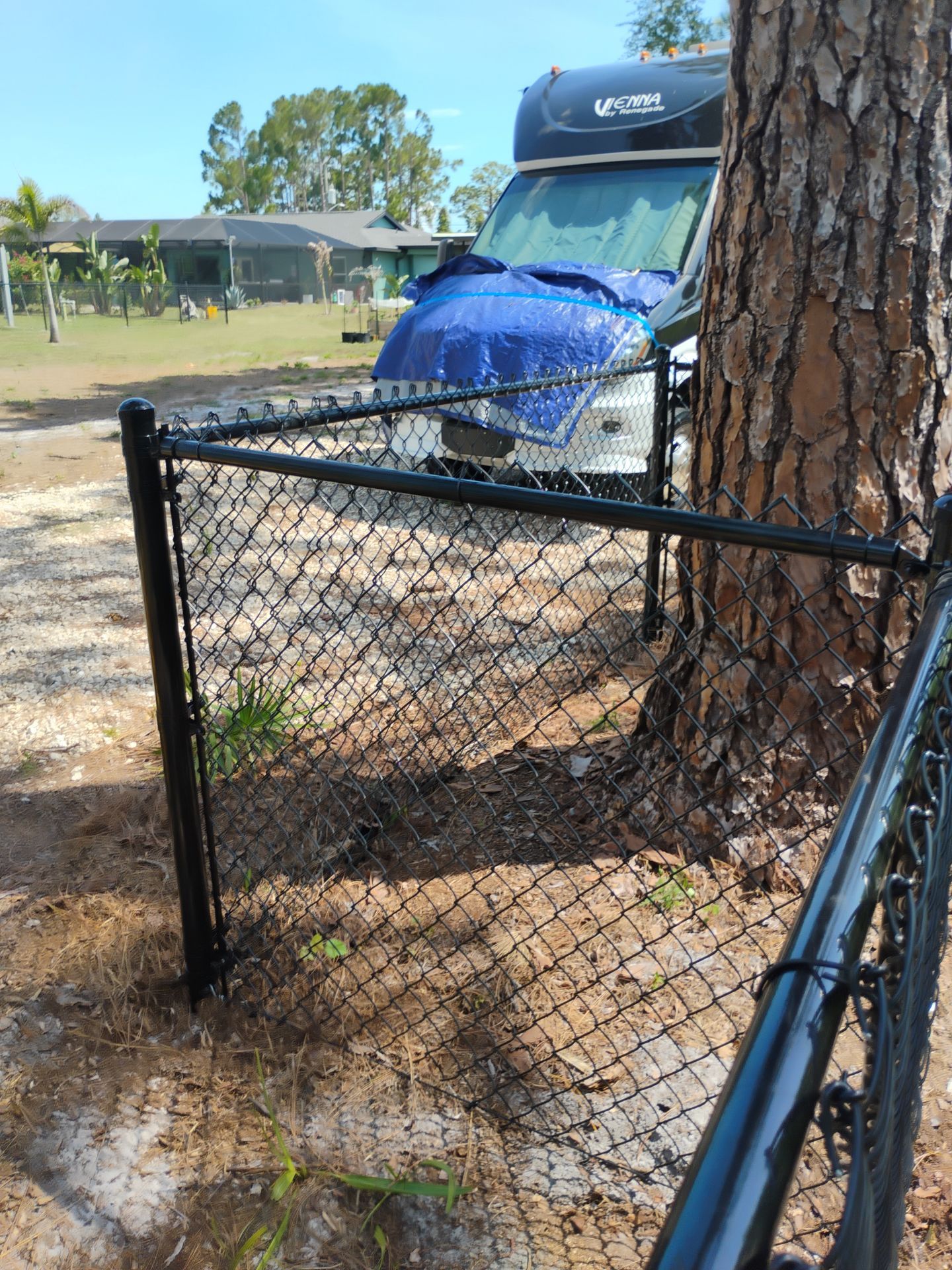 Black Vinyl-Coated Chain Link Fence and Rolling Gate Installation in North Port by True Fence LLC