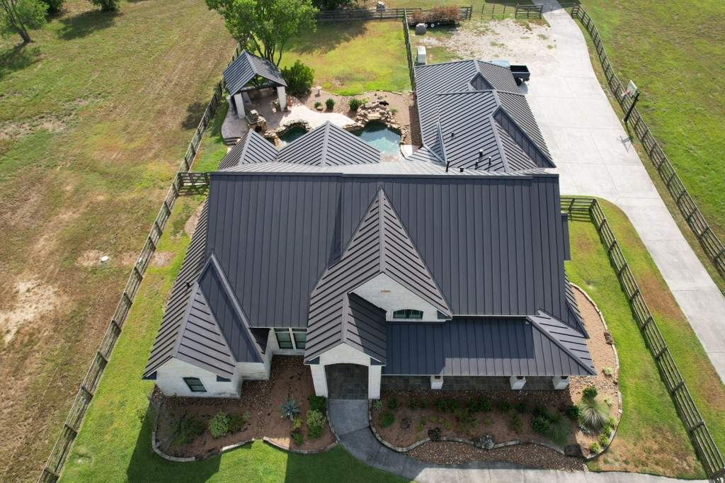 Residential Roofing Installation using Stamding Seam Metal by STX Roofing