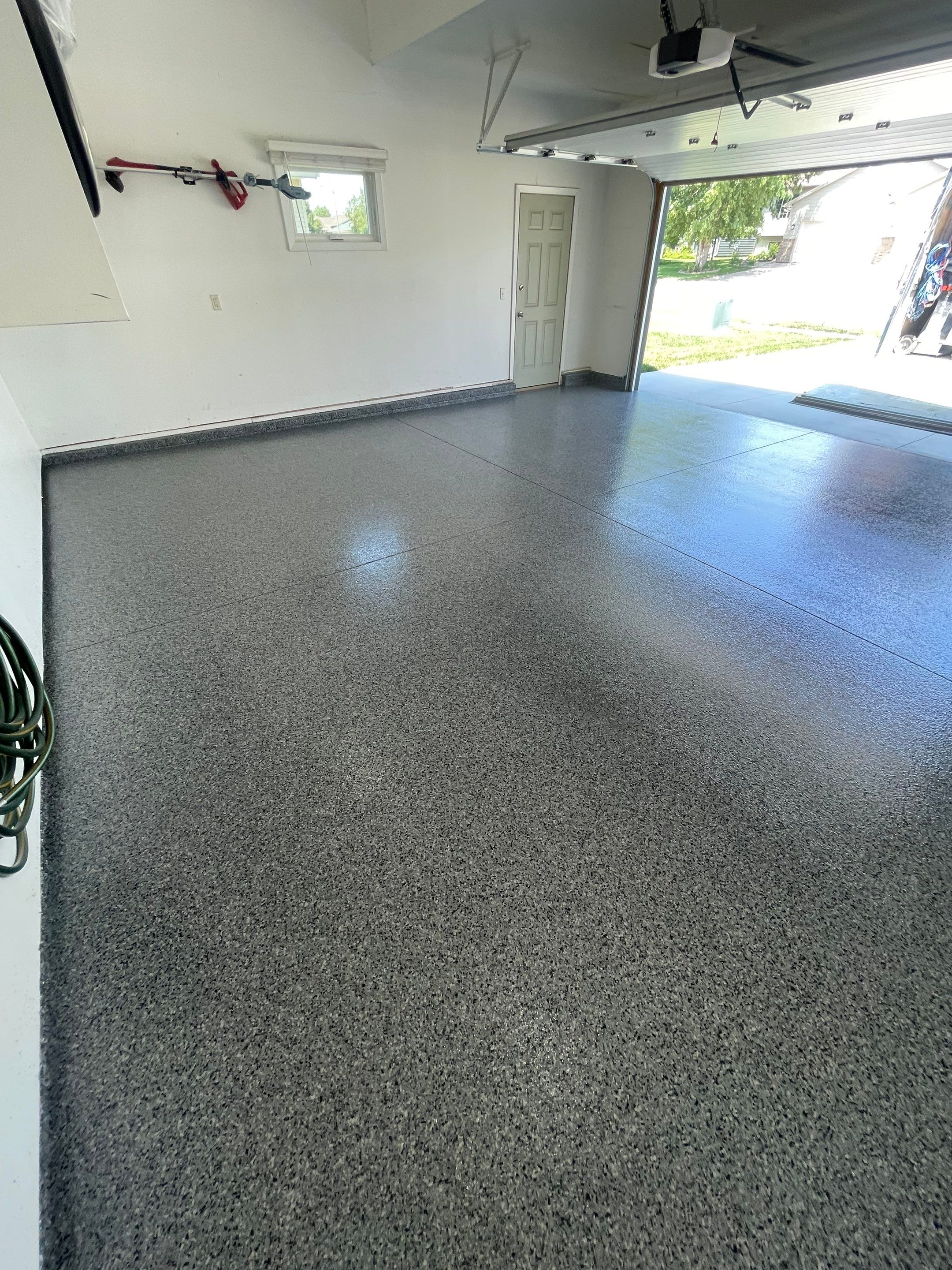 Sioux Falls Garage Floor Coating with Nightfall Decorative Chips by Select Painting, Coatings & Garage Cabinets