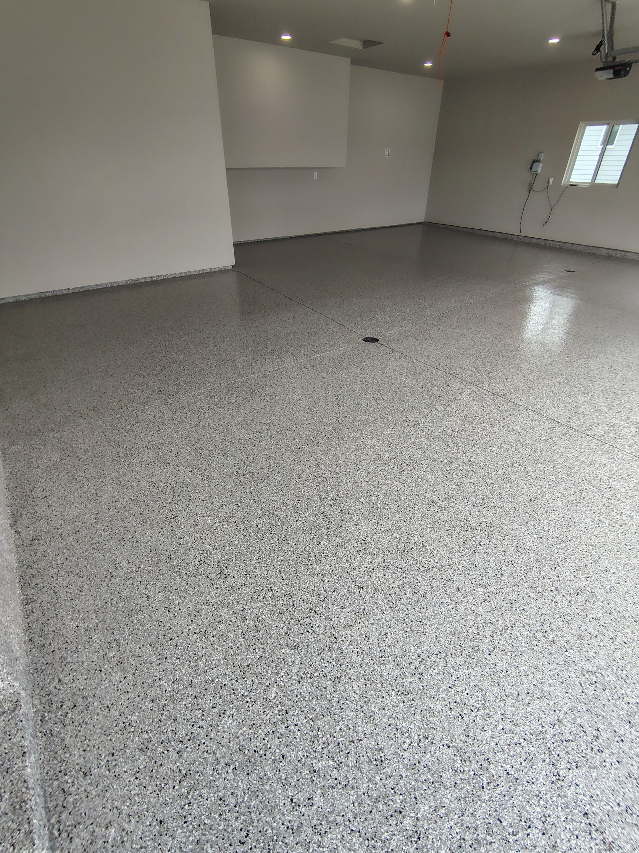 Grey Speckled Epoxy Garage Floor Coating in Sioux Falls by Select Painting, Coatings & Garage Cabinets