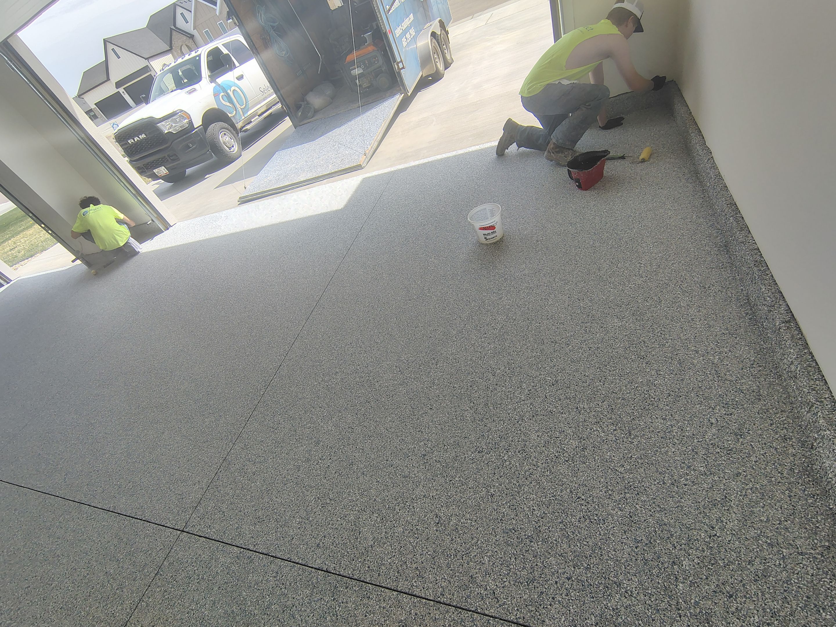 Sioux Falls Garage Floor Transformation with Gray Decorative Flake Coating by Select Painting, Coatings & Garage Cabinets