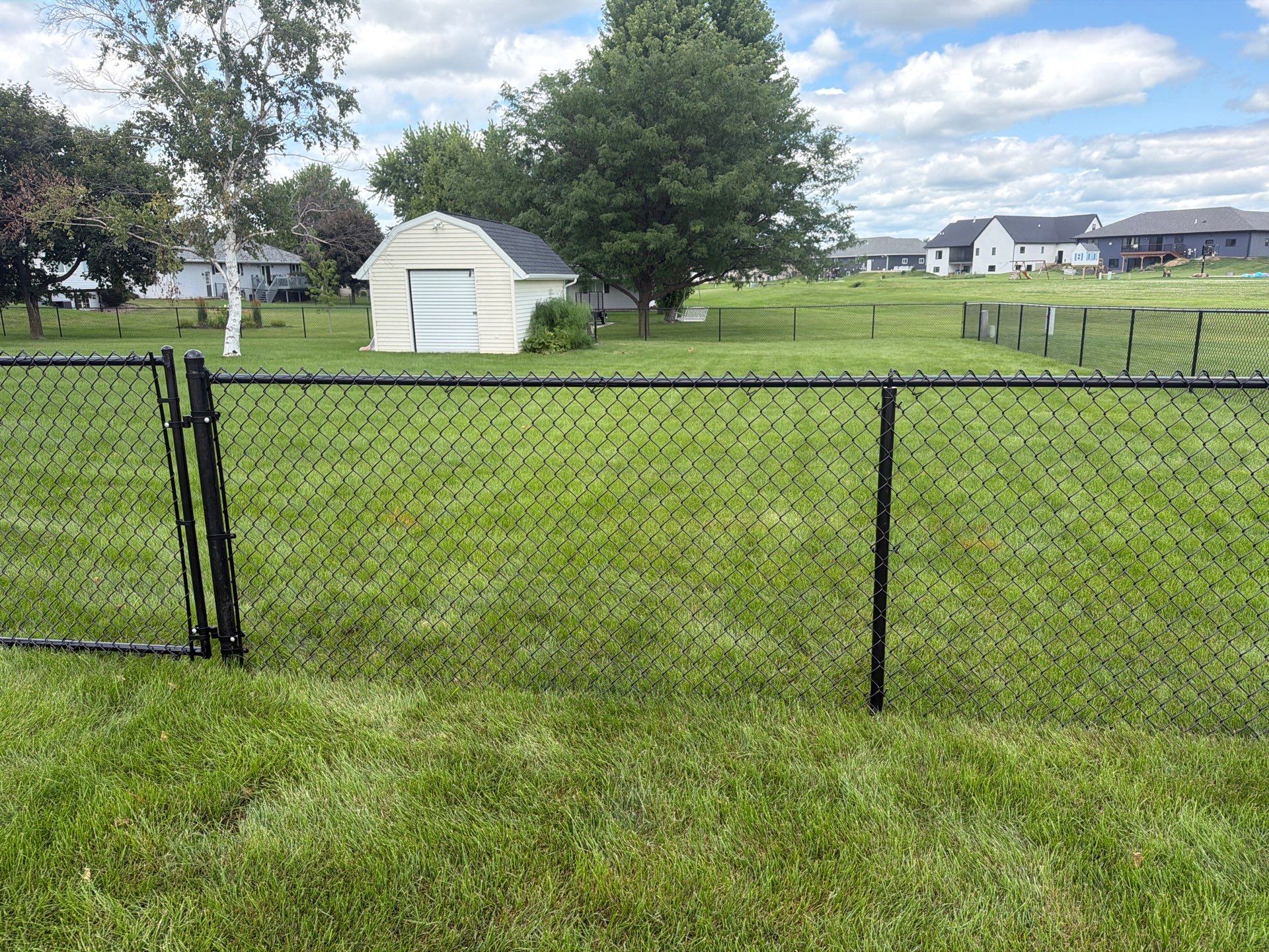 Black Vinyl-Coated Chain Link Fence Installation in Fairbank by Perfect Picket Fence and Stain