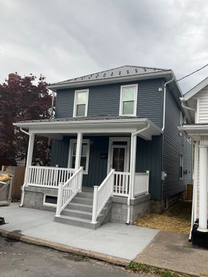 Charcoal Metal Roof & Blue Siding — A Refreshing New Look