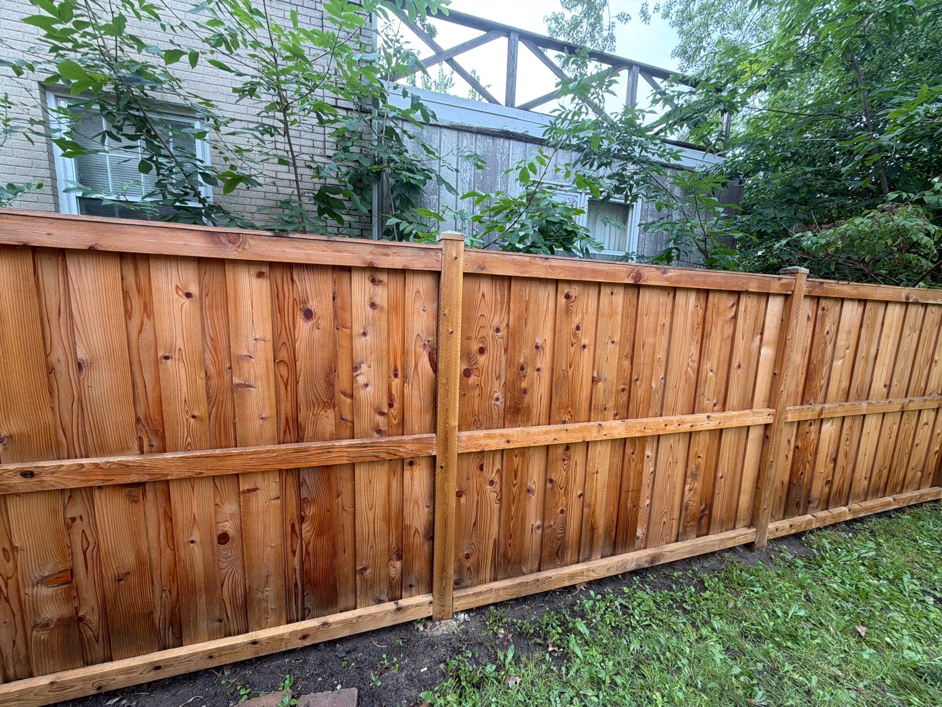 Wood fence cleaning and sealing by Northern Power Washing LLC.
