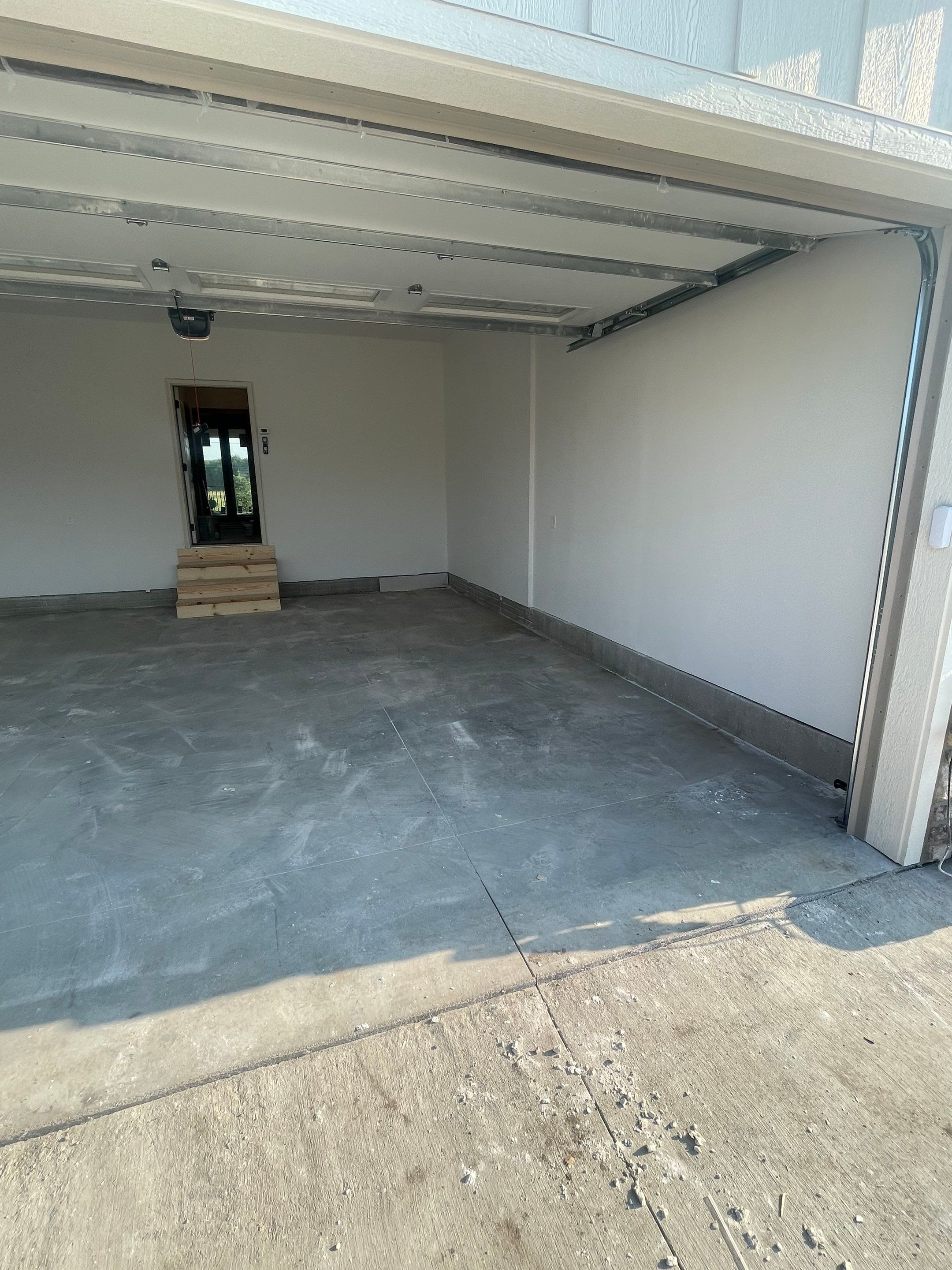 Grey Speckled Garage Floor Coating in Sioux Falls by Select Painting, Coatings & Garage Cabinets