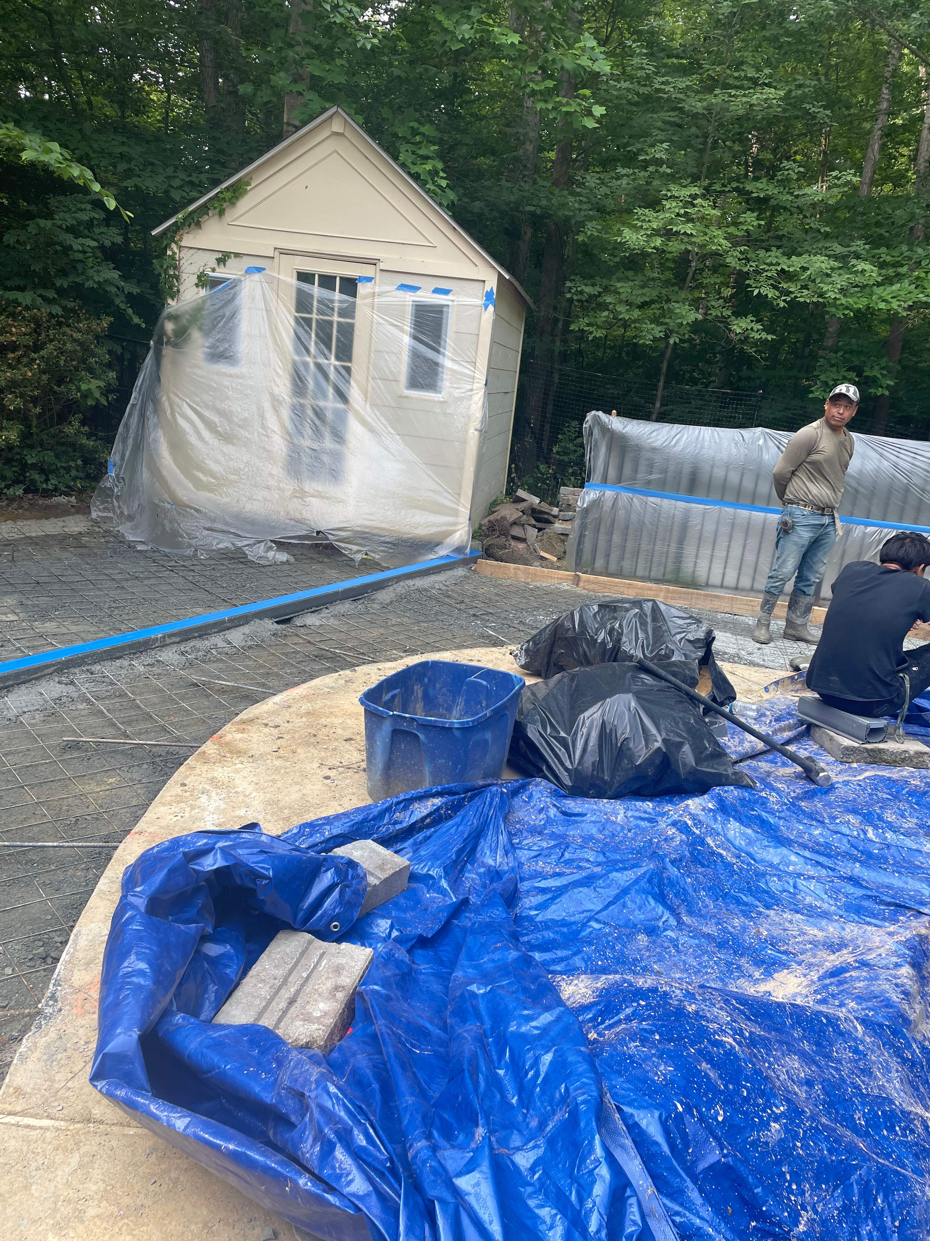 Pool Surround remodel with retaining walls, new waterfall and water slide by Fairfax Contractors, LLC