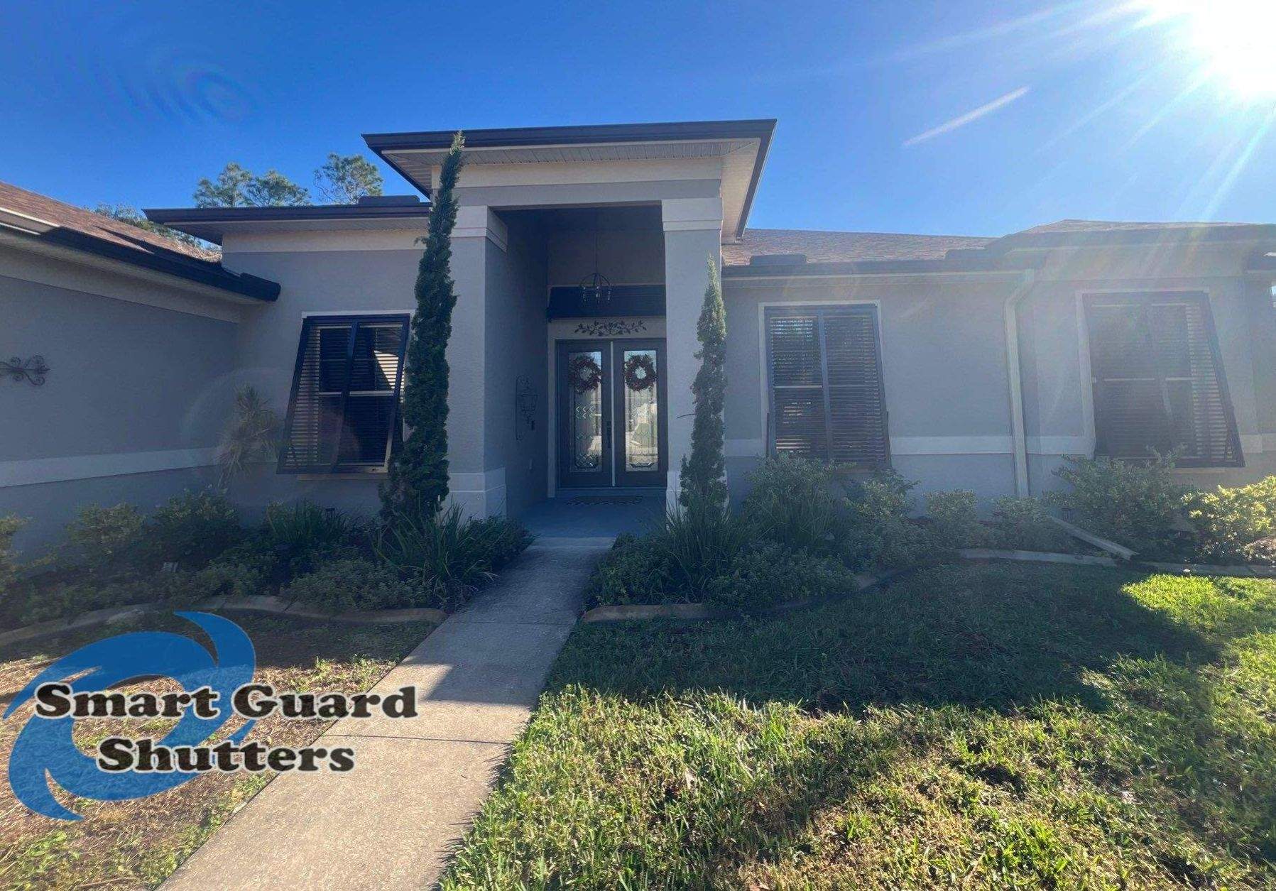 Impact Bahama Shutters in Grey Brown by Smart Guard Shutters