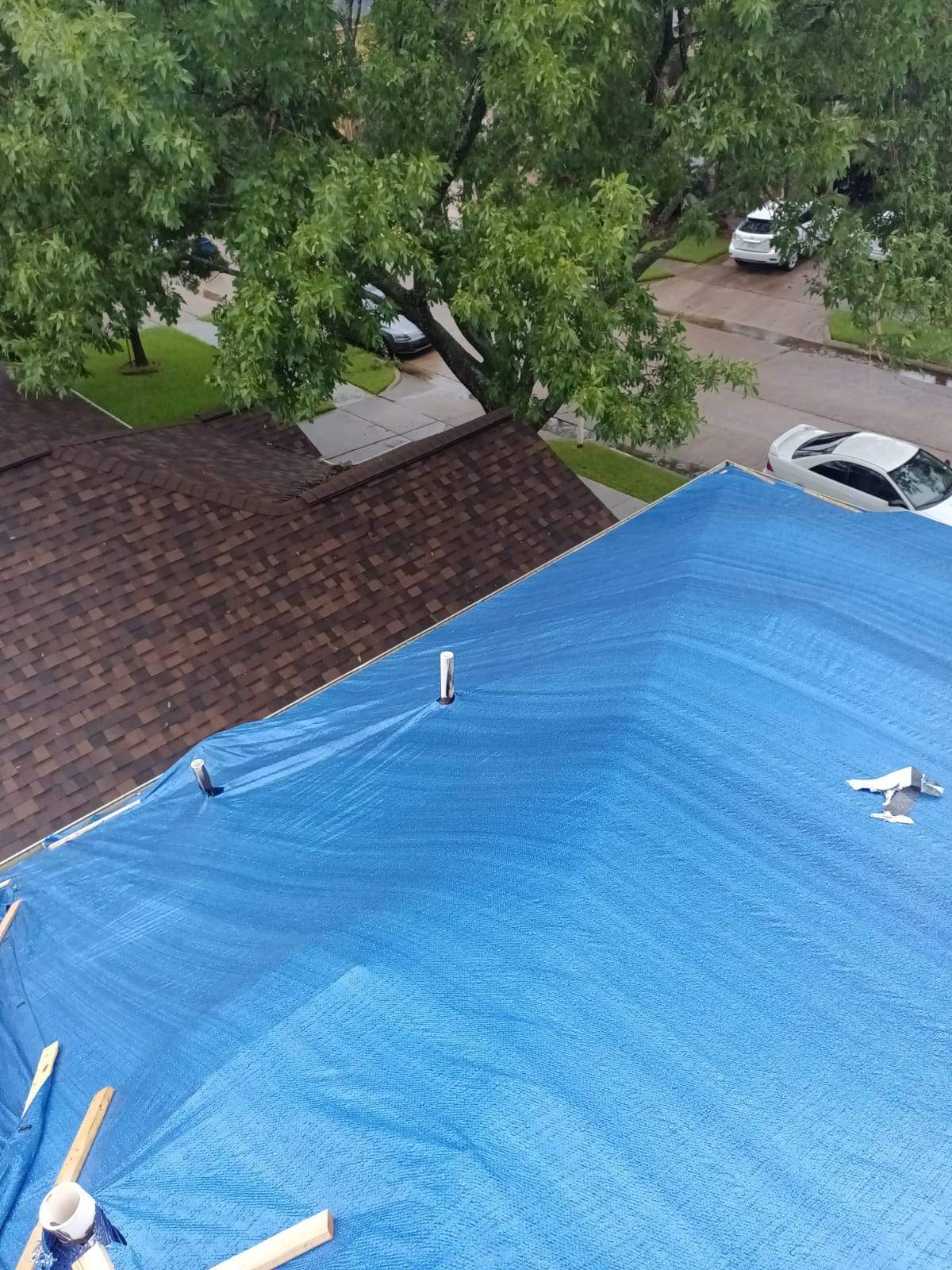 Placement of tarps on the roof. using TARP BLUE by V General Contractors 