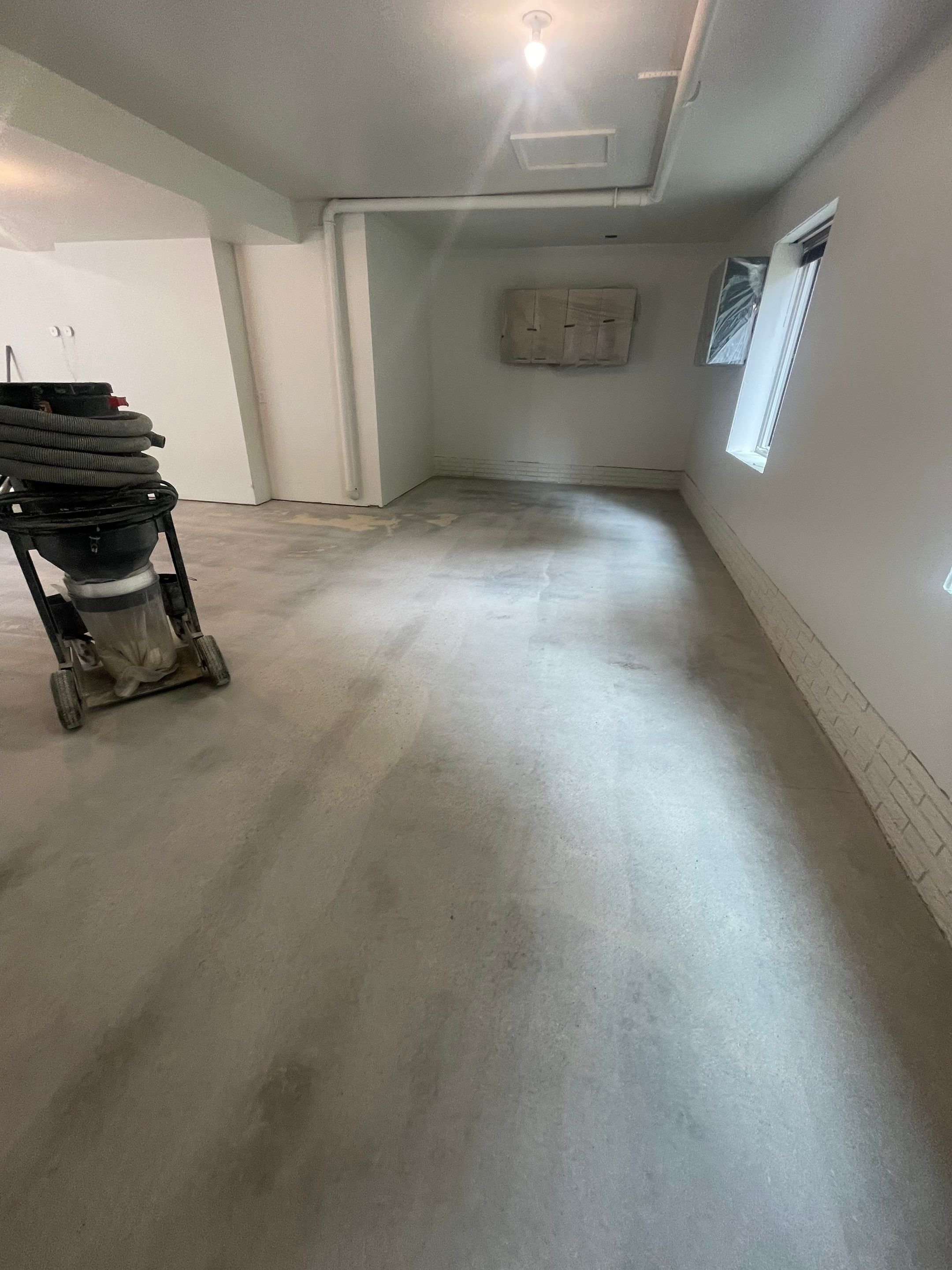 Gray Speckled Epoxy Garage Floor Coating in Sioux Falls by Select Painting, Coatings & Garage Cabinets