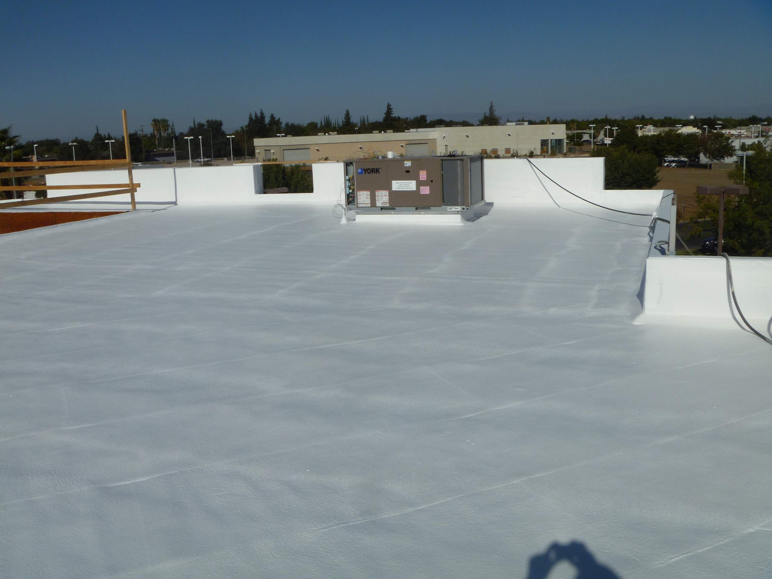 Commercial Roofing Installation using Spray foam and Conklin Benchmark/PUMA XL 18 yr warranty coatings by Straight Edge Roofing Inc
