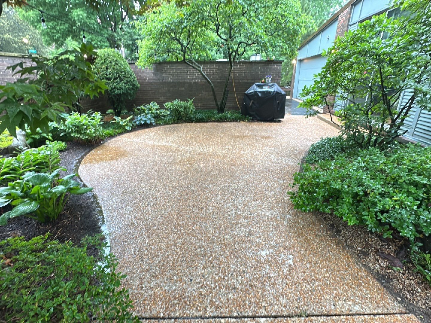 Aggregate and natural stone patio cleaning by Northern Power Washing LLC.