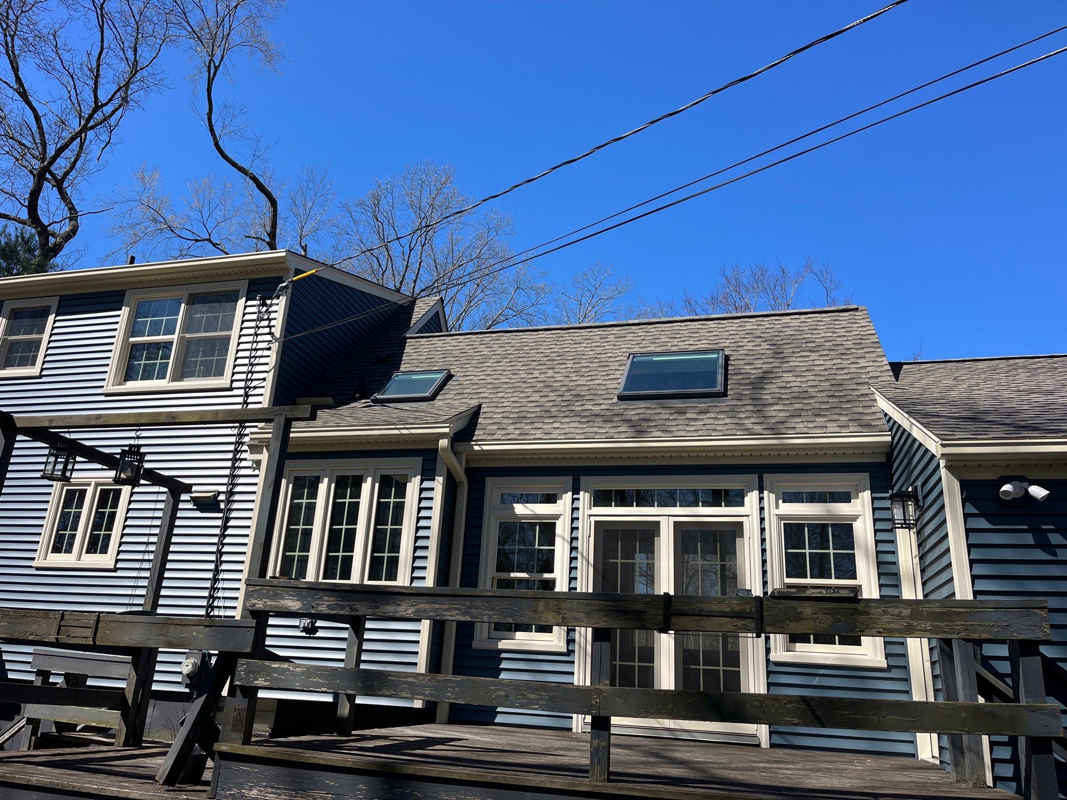 Asphalt shingles meet sleek siding in Guilford. by DiGiorgi Roofing and Siding Inc