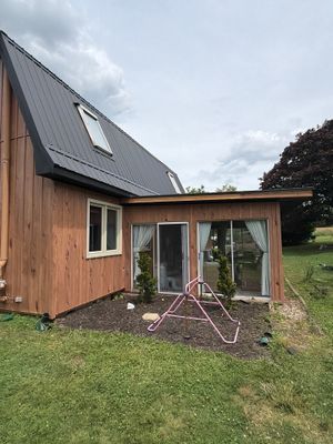 Complete Exterior Transformation with Textured Black Metal Roofing and Hickory Board-and-Batten Siding in Hebron