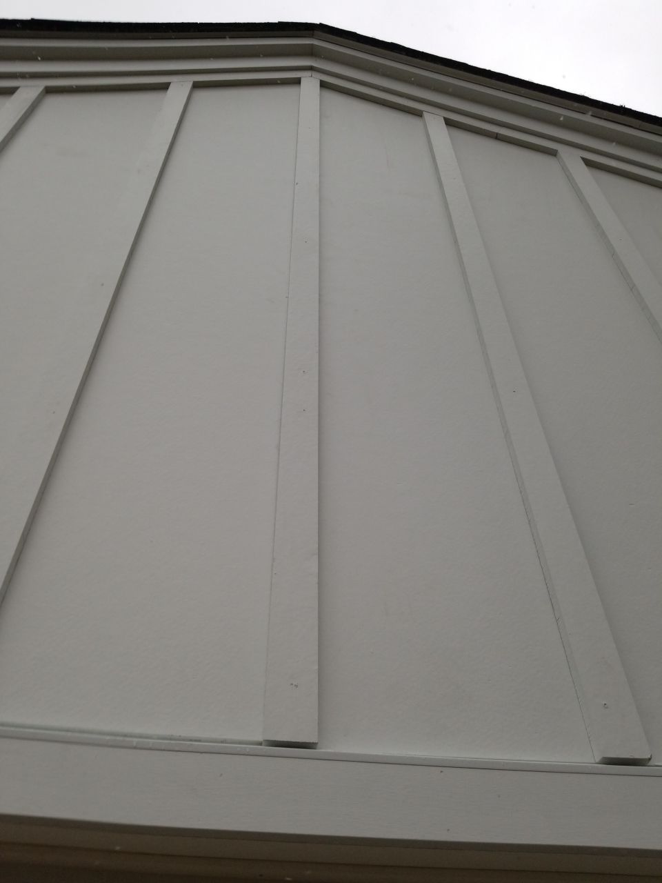 James Hardie Siding  using James Hardie Board and Batten, White by Absolute Roofing and Construction