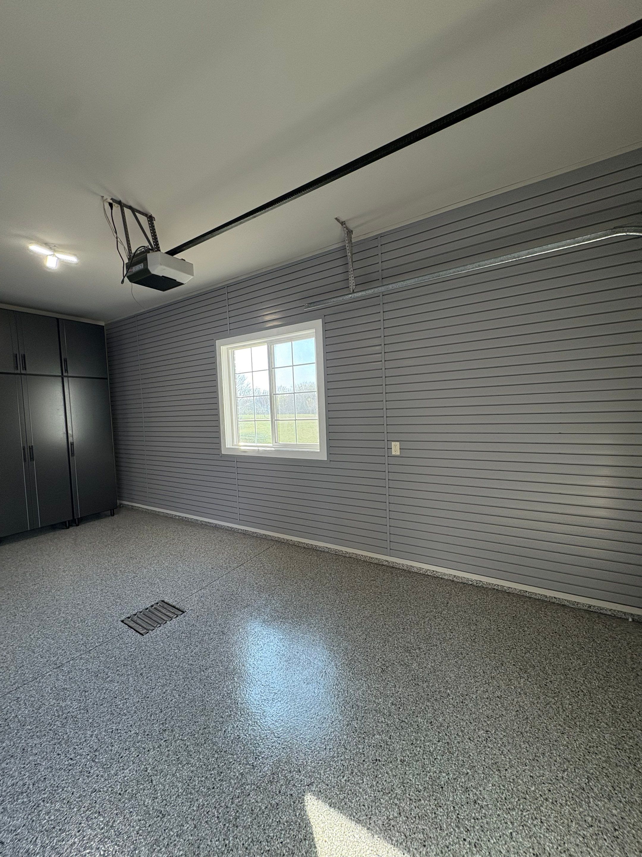 Yankton Garage Transformation with Dark Storage Cabinetry and Epoxy Flooring by Select Painting, Coatings & Garage Cabinets