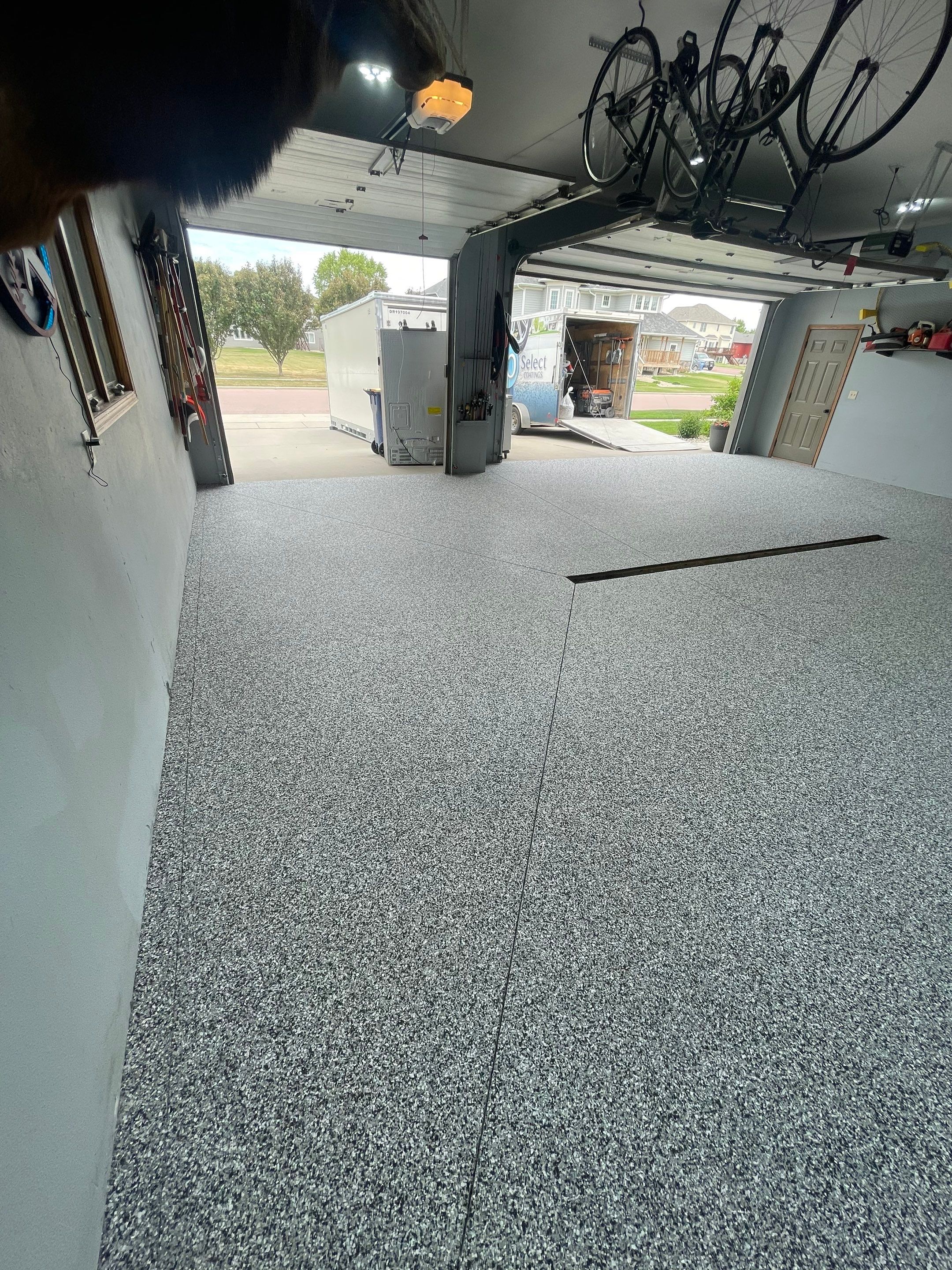 Full Garage Floor Epoxy Coating Installation in Dell Rapids by Select Painting, Coatings & Garage Cabinets