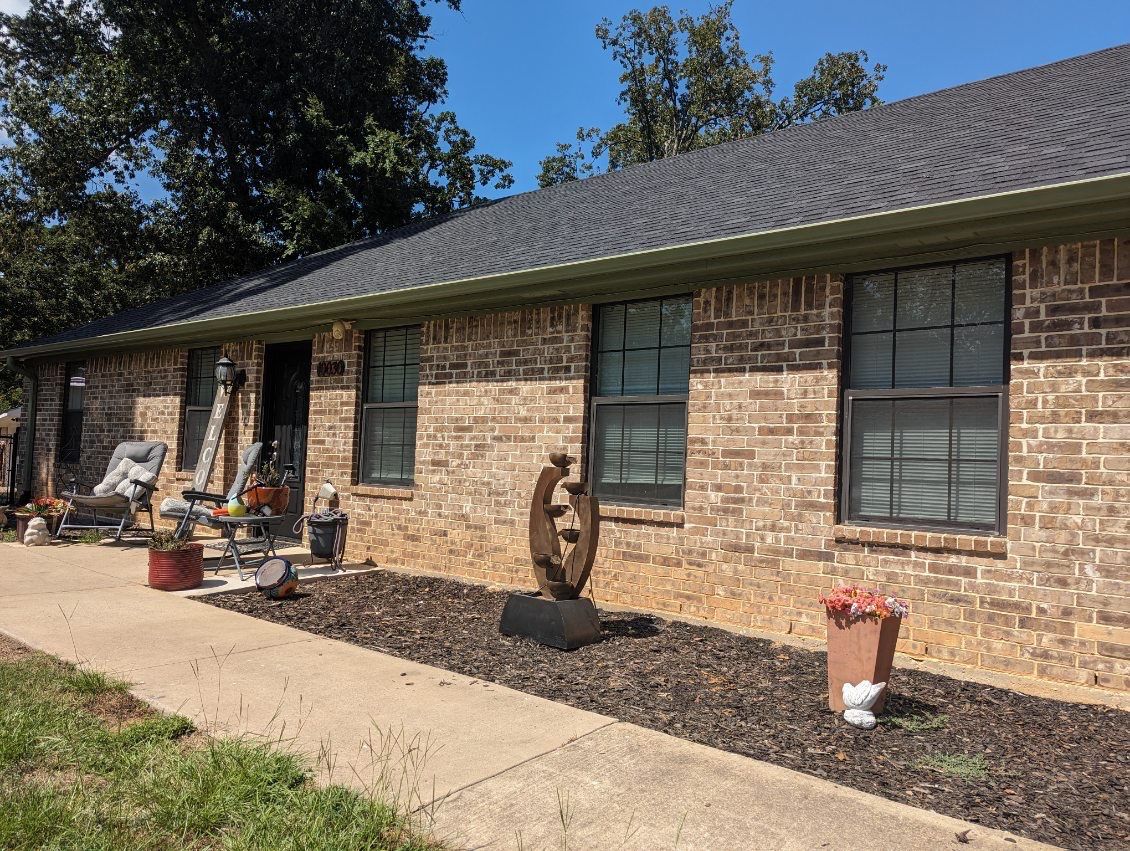 Exterior Repaint – Tyler, Texas - Bold green color with black garage by Quality Coats Painting