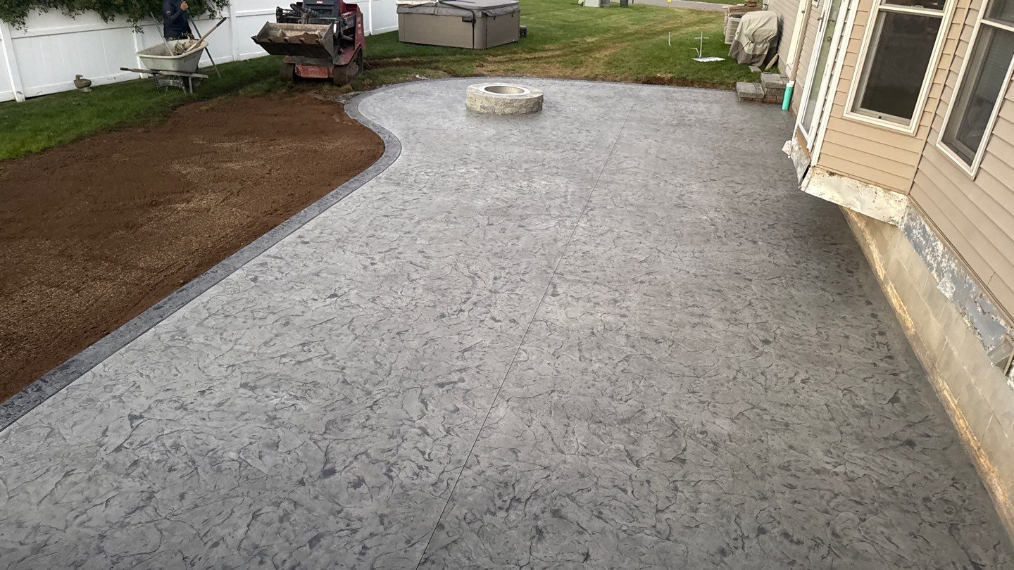 Oxford slate stamped concrete patio  by NG Masonry & Construction LLC