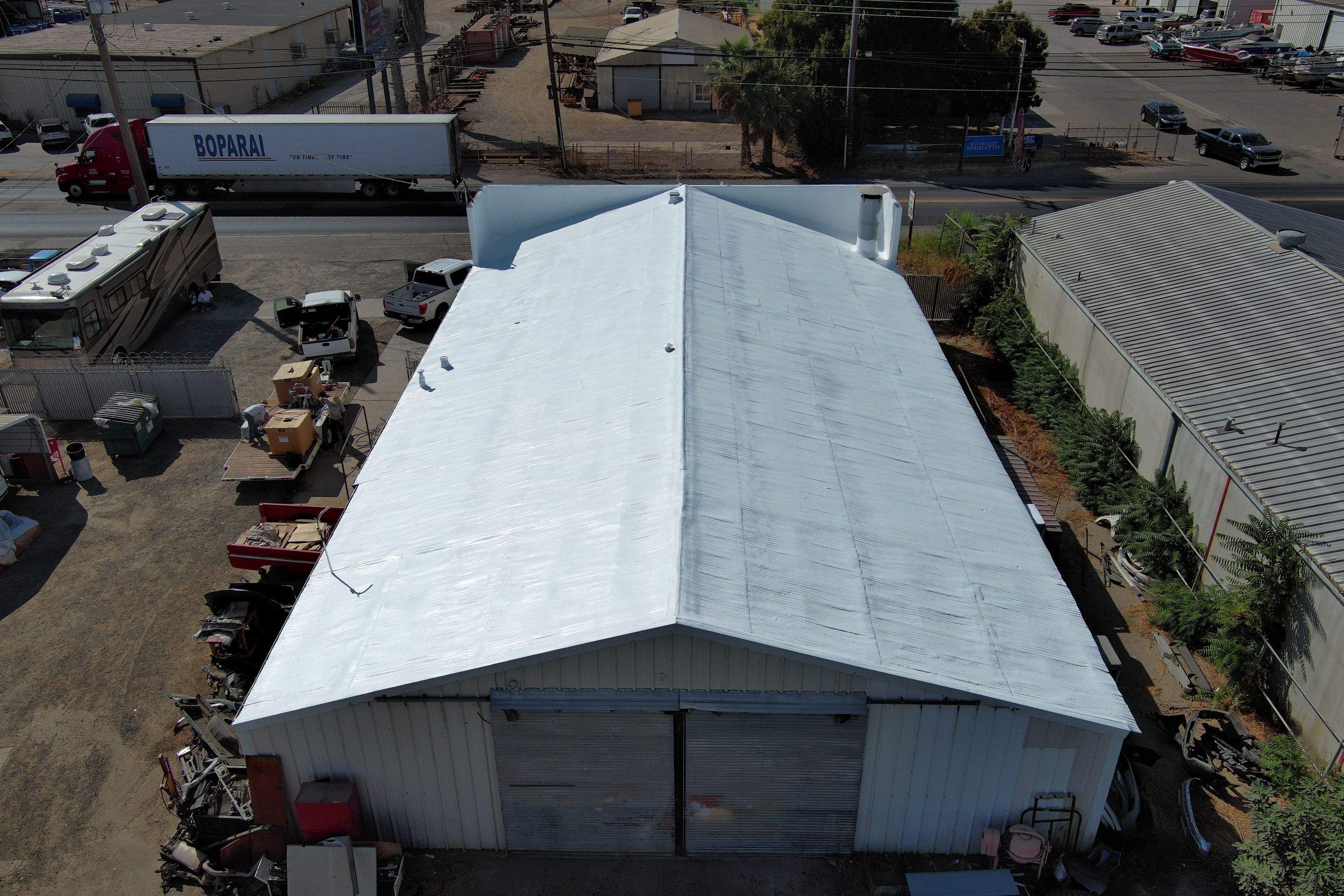 Spray foam and coatings using Conklin Benchmark/ PUMA XL acrylic coatings over metal and foam by Straight Edge Roofing Inc