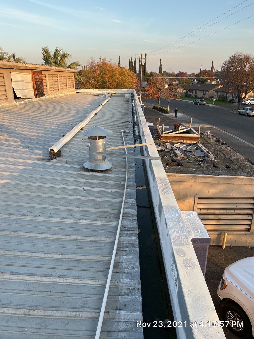Metal roof restoration on commercial roof using Conklin Benchmark/ PUMA XL acrylic coatings over metal and foam by Straight Edge Roofing Inc