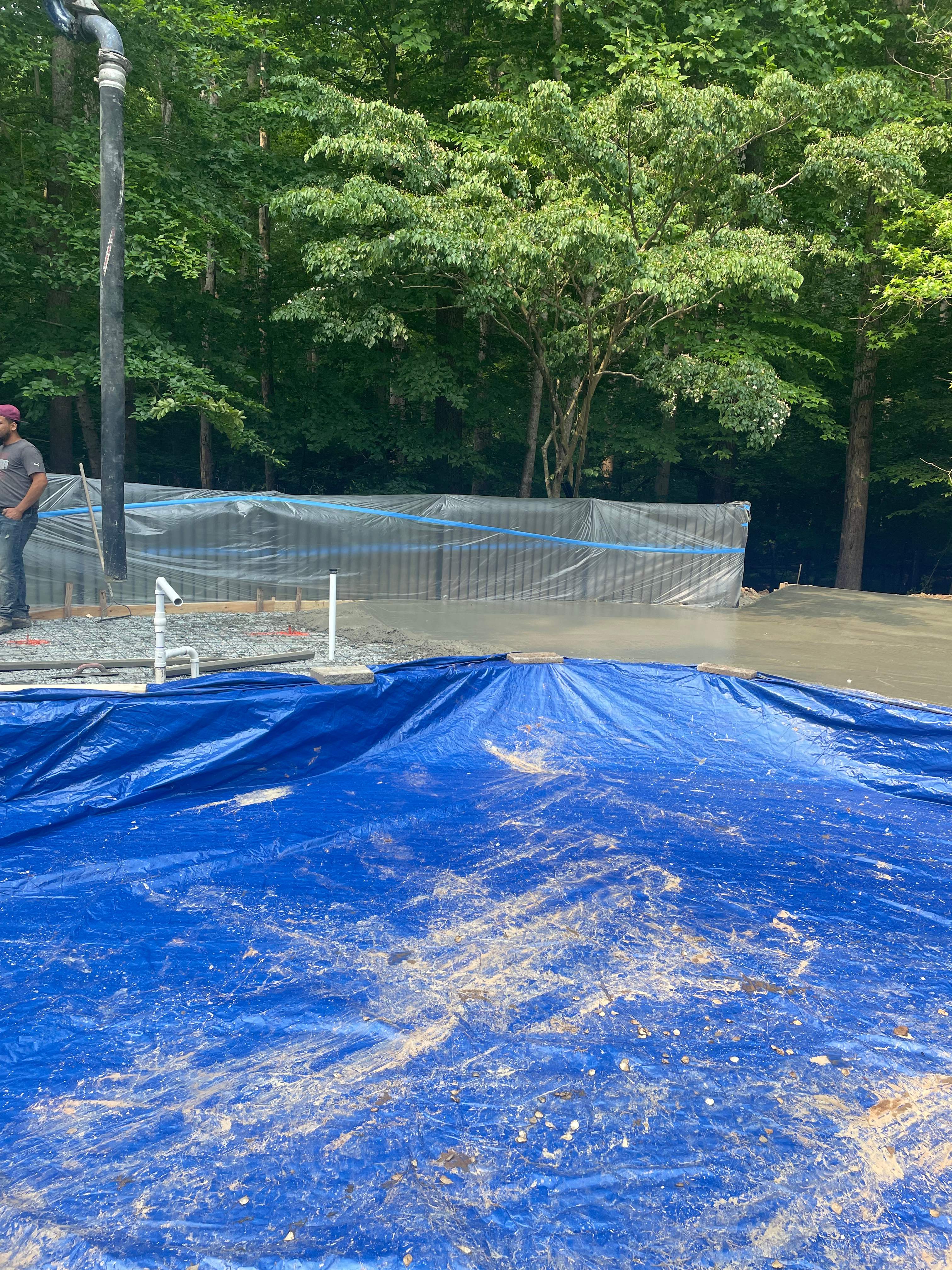 Pool Surround remodel with retaining walls, new waterfall and water slide by Fairfax Contractors, LLC