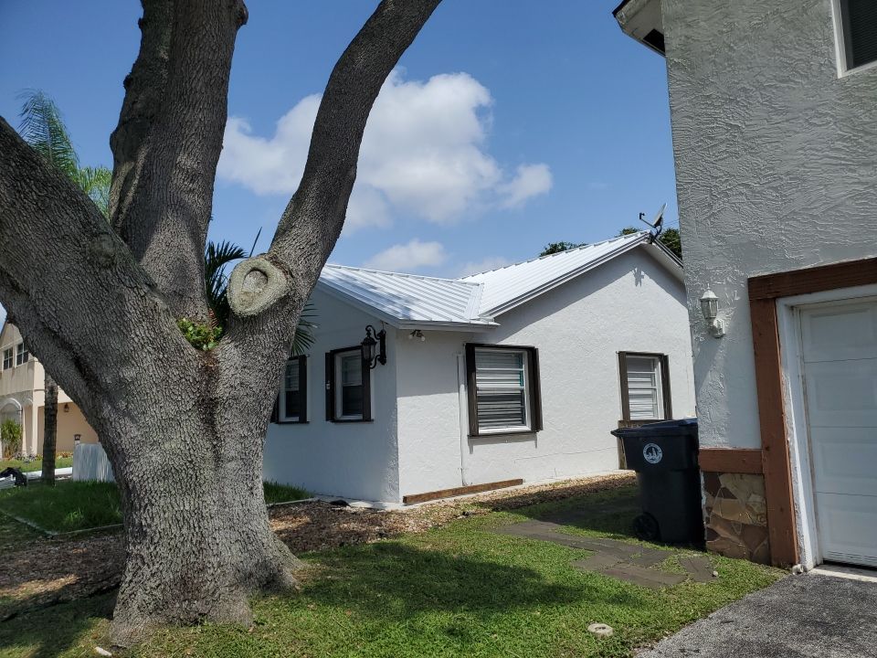 Residential Roofing Installation using 1.5" Nail Strip 24ga Solar White Kynar Coated Standing Seam Metal Panels by Morton Roofing, Inc.