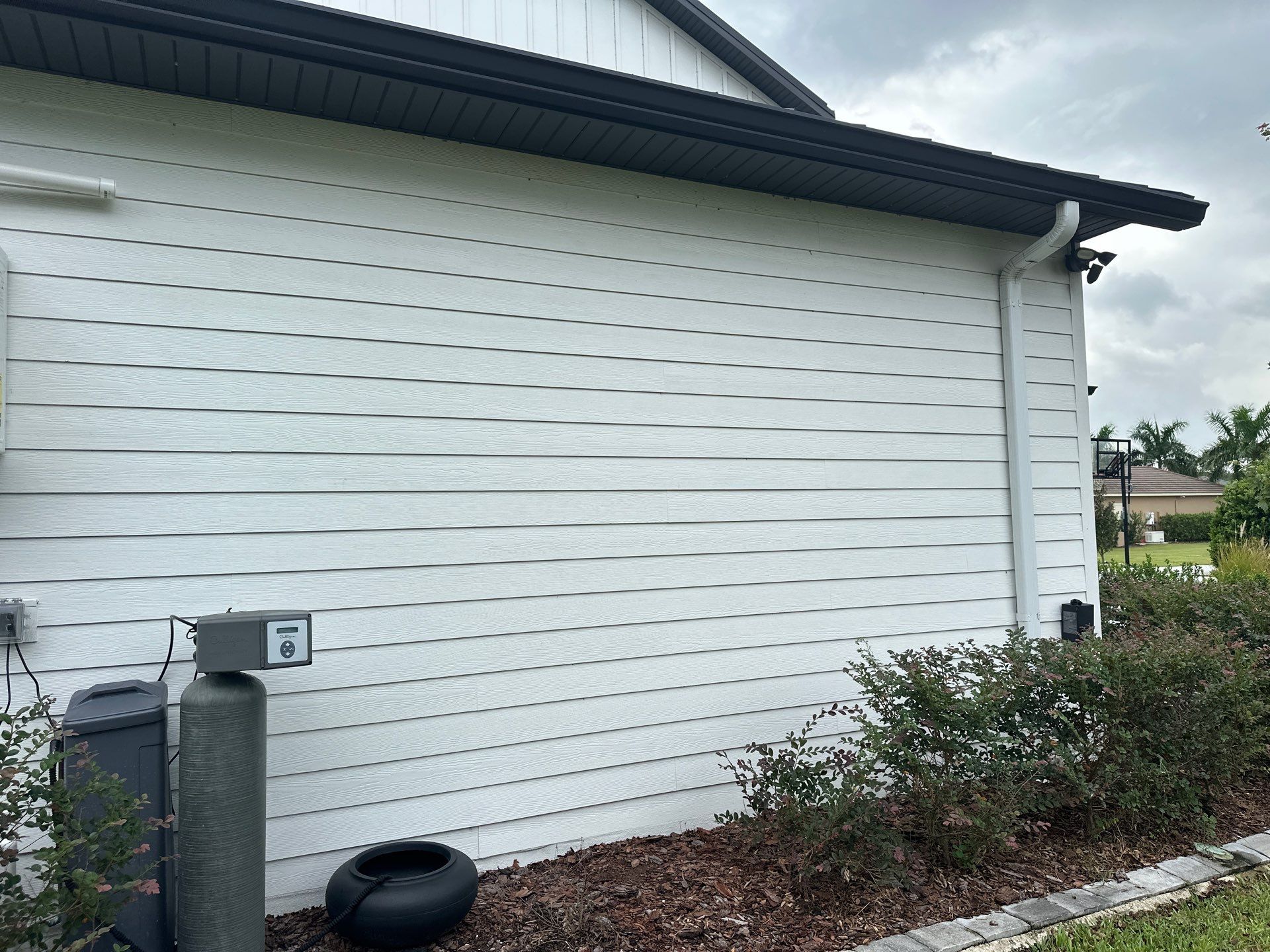 Complete Two-Story House Wash and Driveway Cleaning in Winding River Community, Bradenton, FL by Sunshine AquaWash