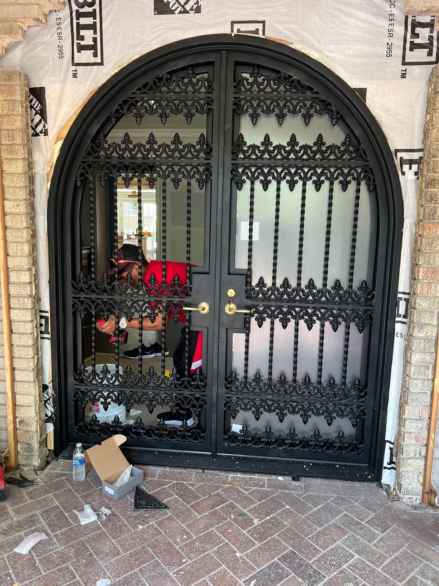 Custom Arched Black Wrought Iron Double Door Installation in Dallas by Solara Custom Living