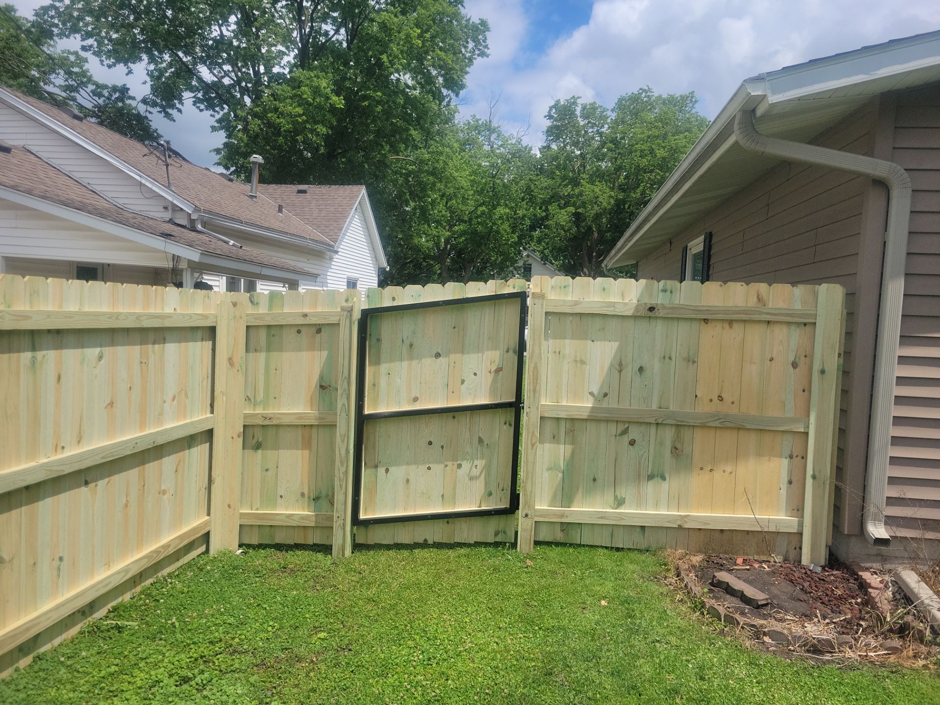 Pressure-Treated Wood Privacy Fence Installation in Charles City by Perfect Picket Fence and Stain