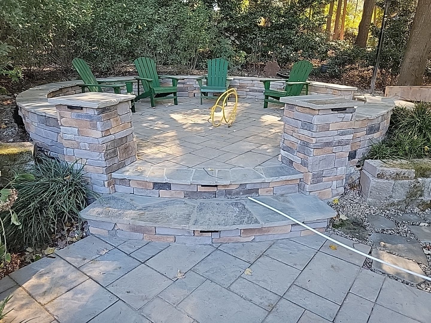 New Deck, Stone Fountain Feature, Circle Stone Sitting Area with Fireplace by The Remodeling Company