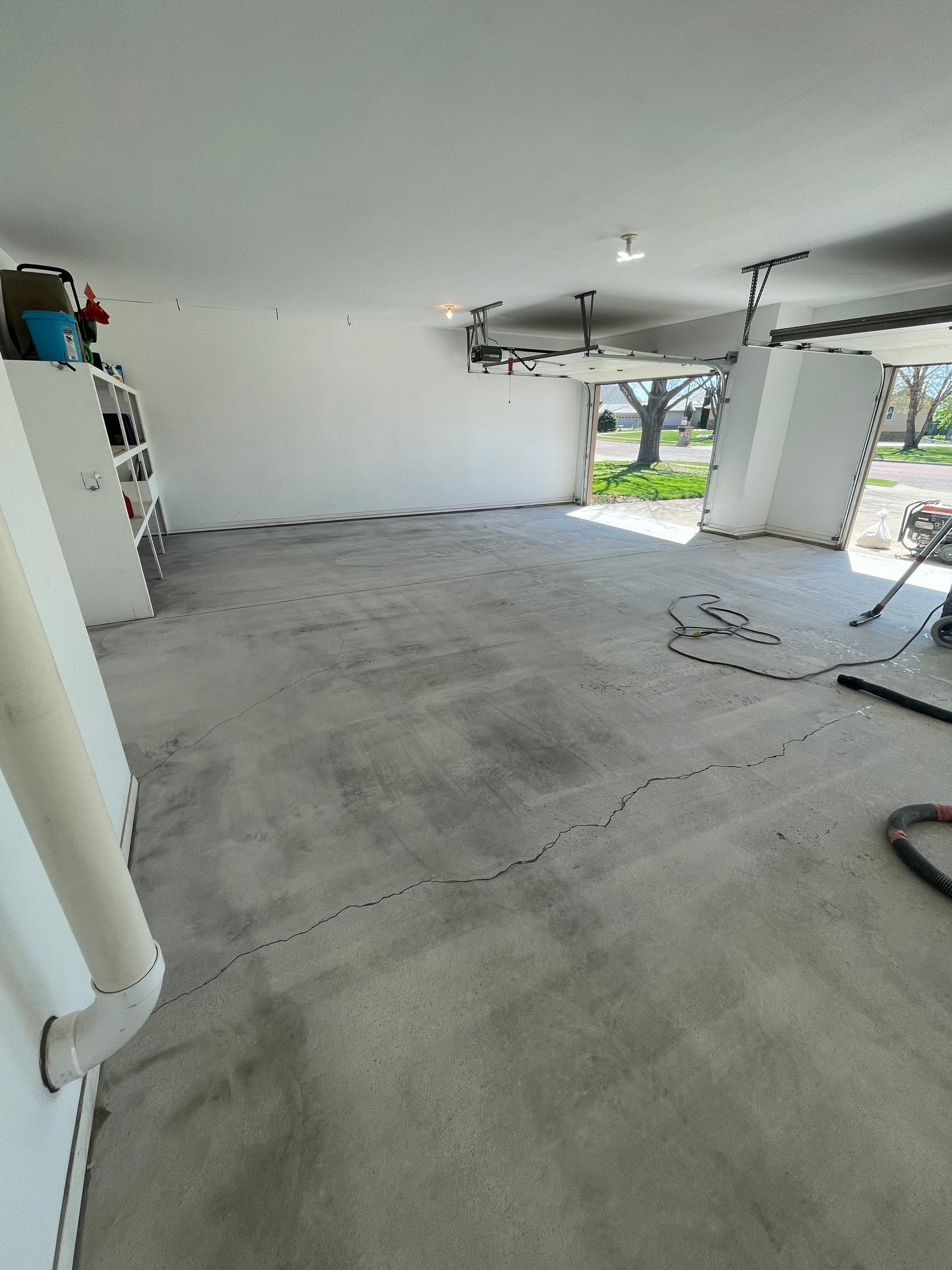 Yankton Garage Floor Restoration with Gray Speckled Epoxy Coating by Select Painting, Coatings & Garage Cabinets
