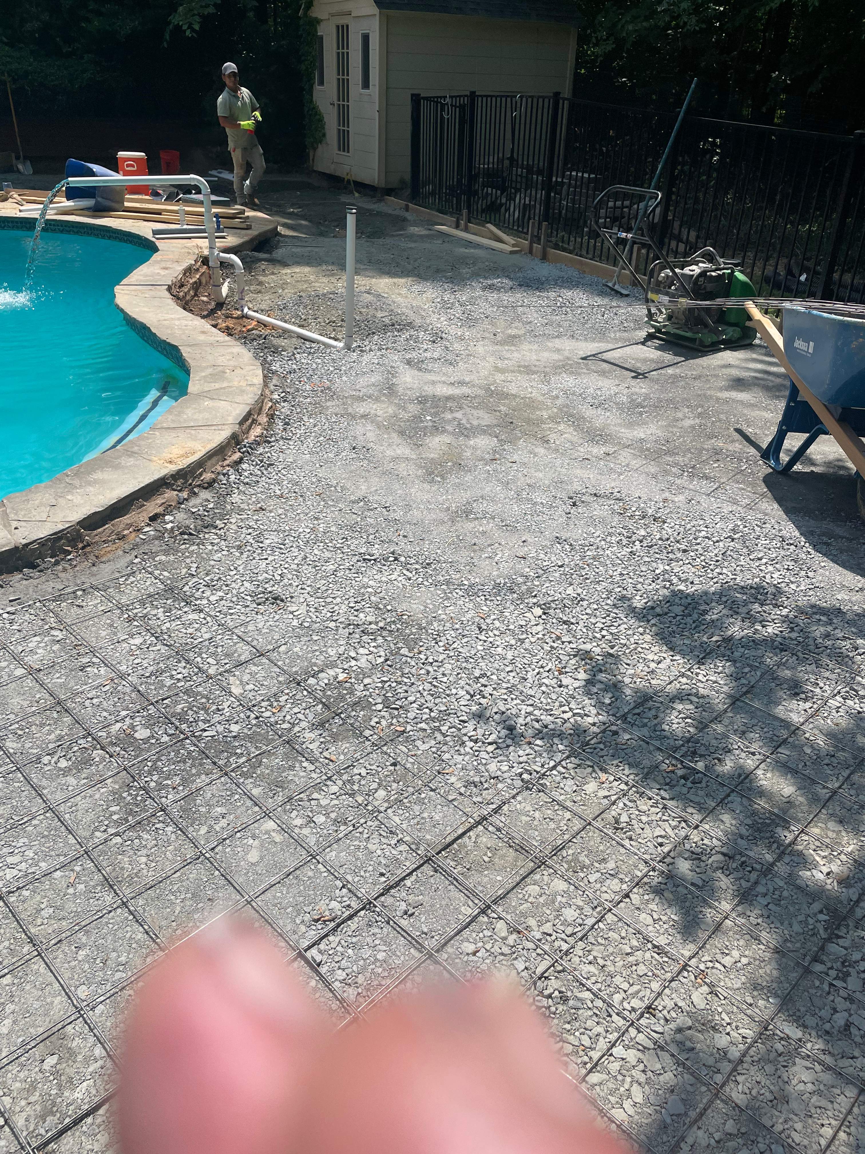 Pool Surround remodel with retaining walls, new waterfall and water slide by Fairfax Contractors, LLC