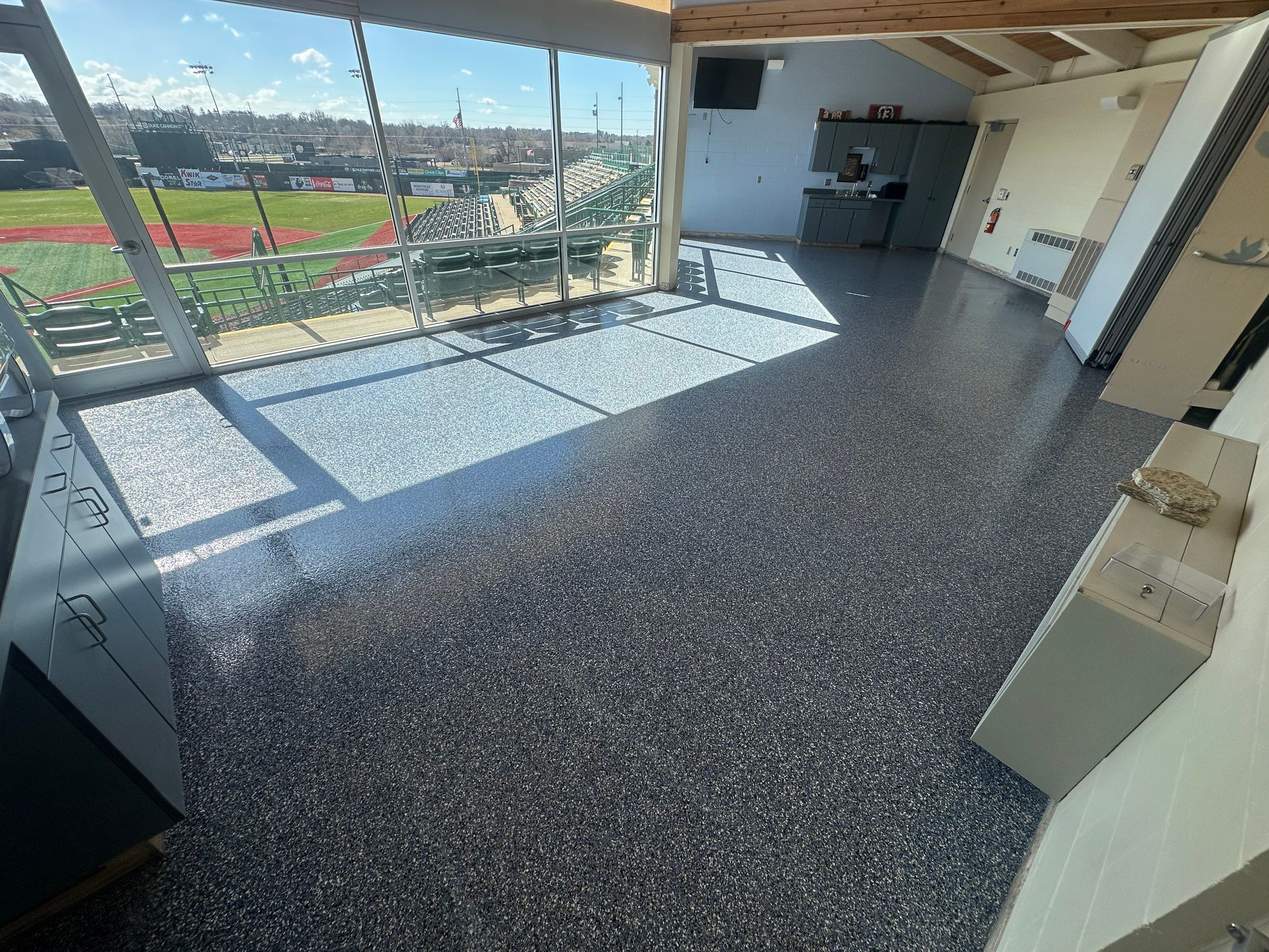Commercial Epoxy Floor Coating for Stadium Viewing Suites in Sioux Falls by Select Painting, Coatings & Garage Cabinets