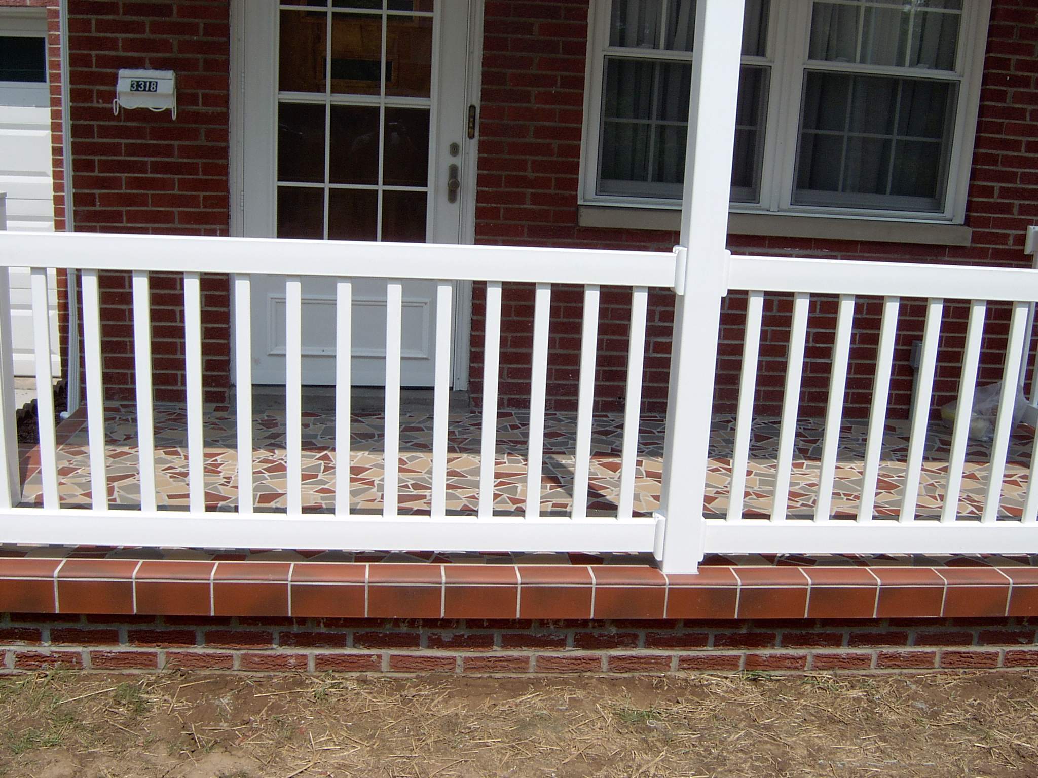 New front porch build, with tile floor and vinyl railing. by Secure Construction Company Inc