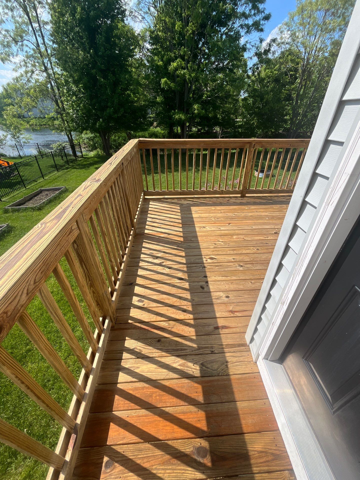 wood deck cleaning and staining by Northern Power Washing LLC.