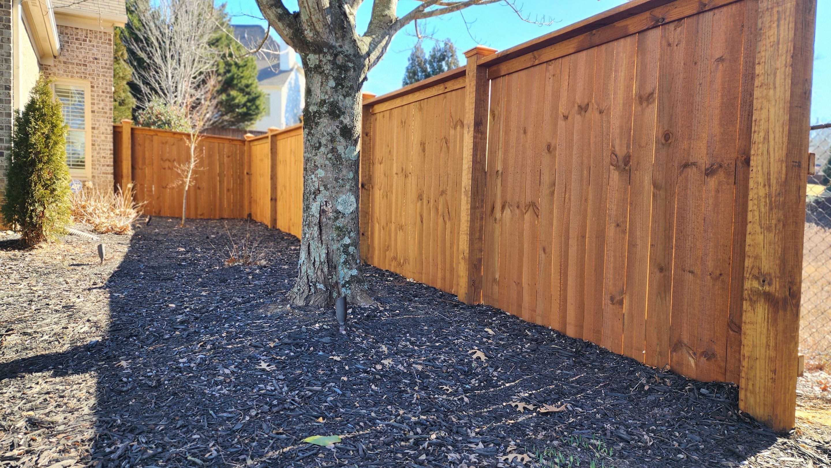 Fence Installation of Capped Wood Privacy Fence using 6X6 posts and copper post caps.  by Titans of Timber Fence & Stain