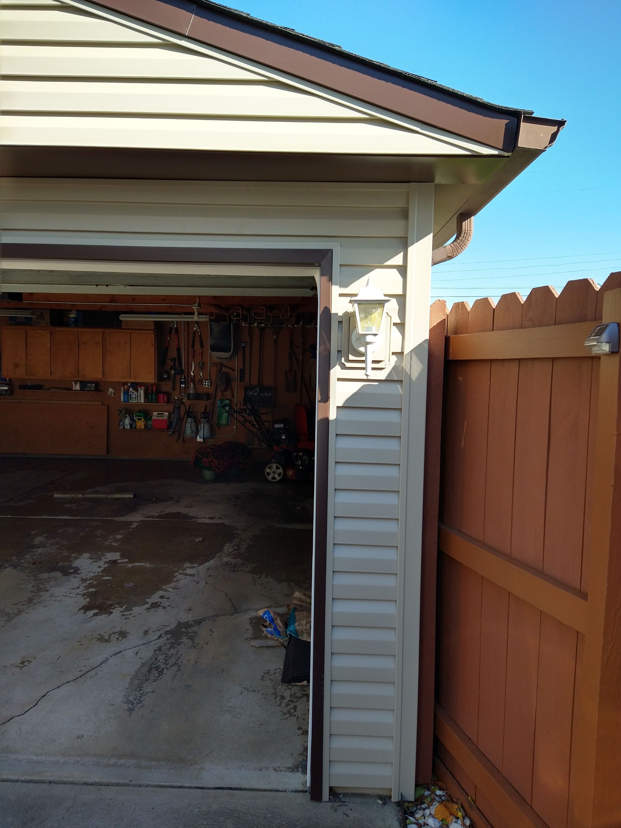 Siding Installation using Norandex woodsman dl-5 white woodgrain vinyl by Absolute Roofing and Construction